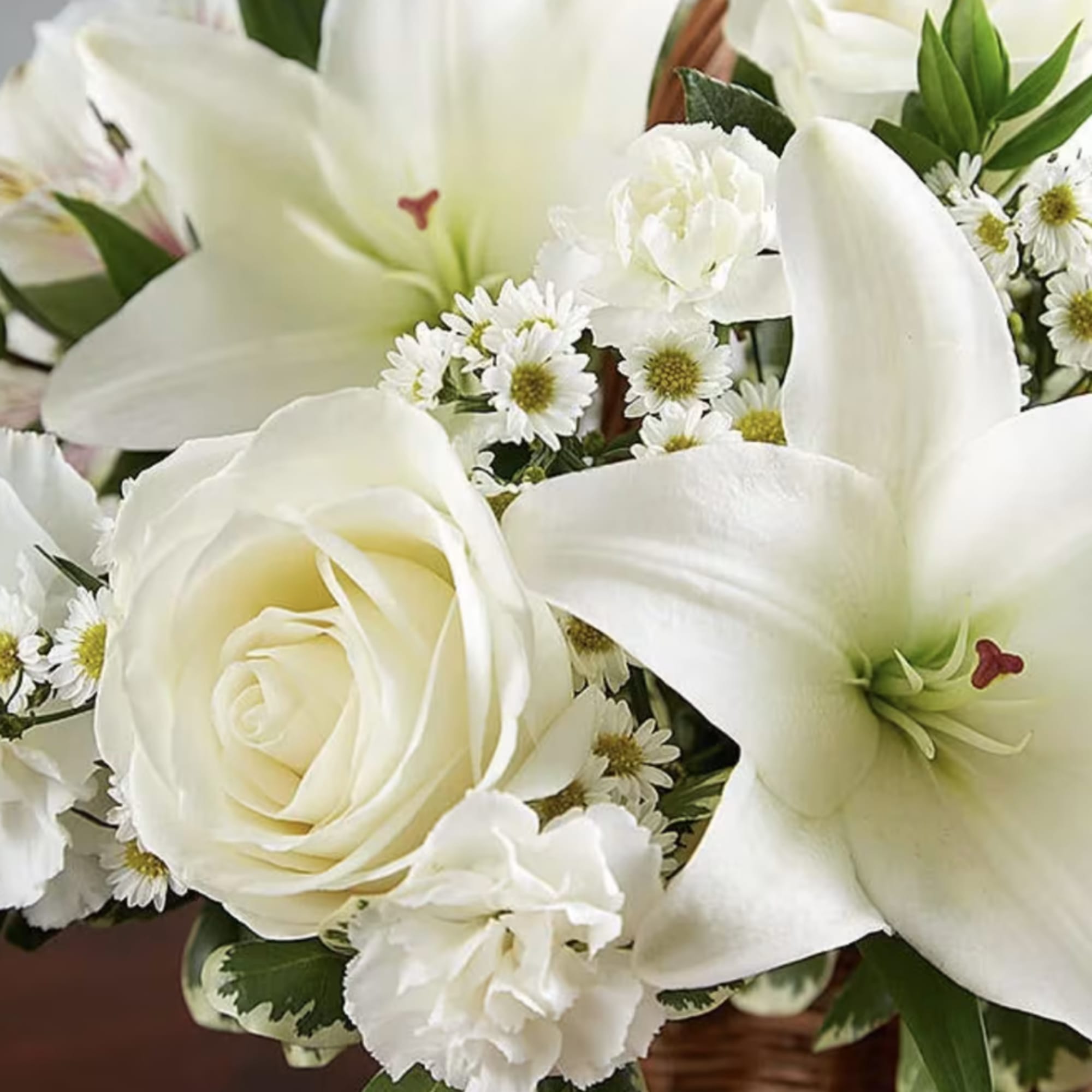 A natural wicker basket is filled with serene selection of white beautiful