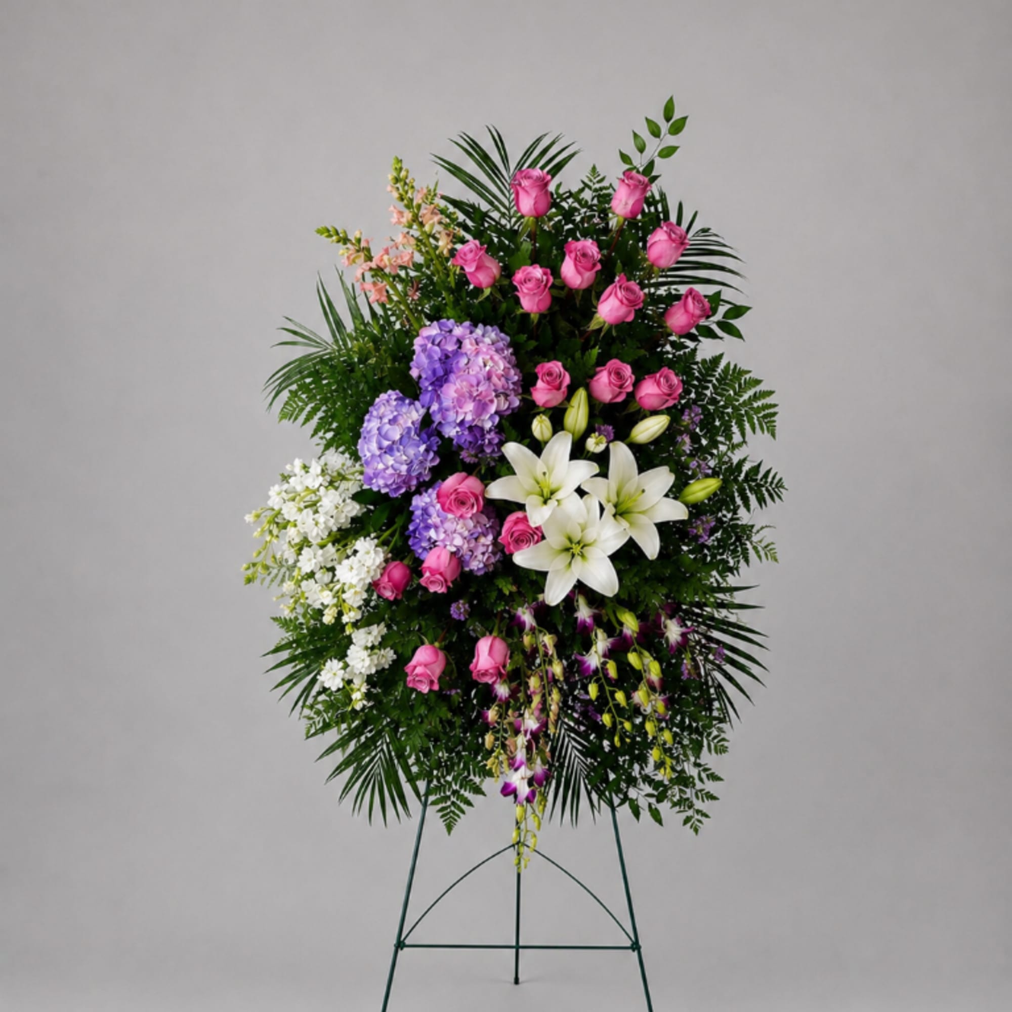 Standing floral spray with pink roses, white lilies, and purple hydrangeas