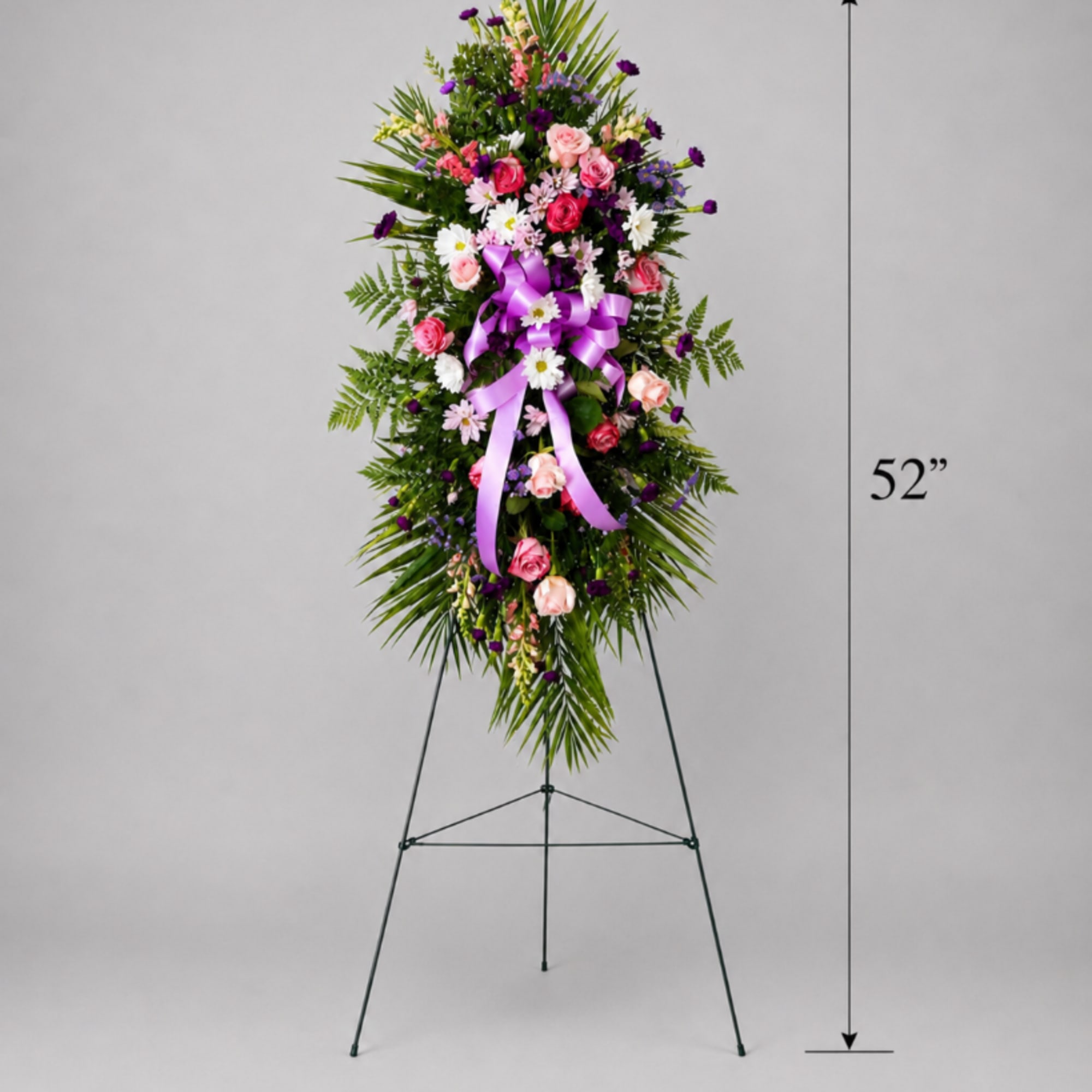 Tall standing floral spray with pink, white, and purple flowers on an easel