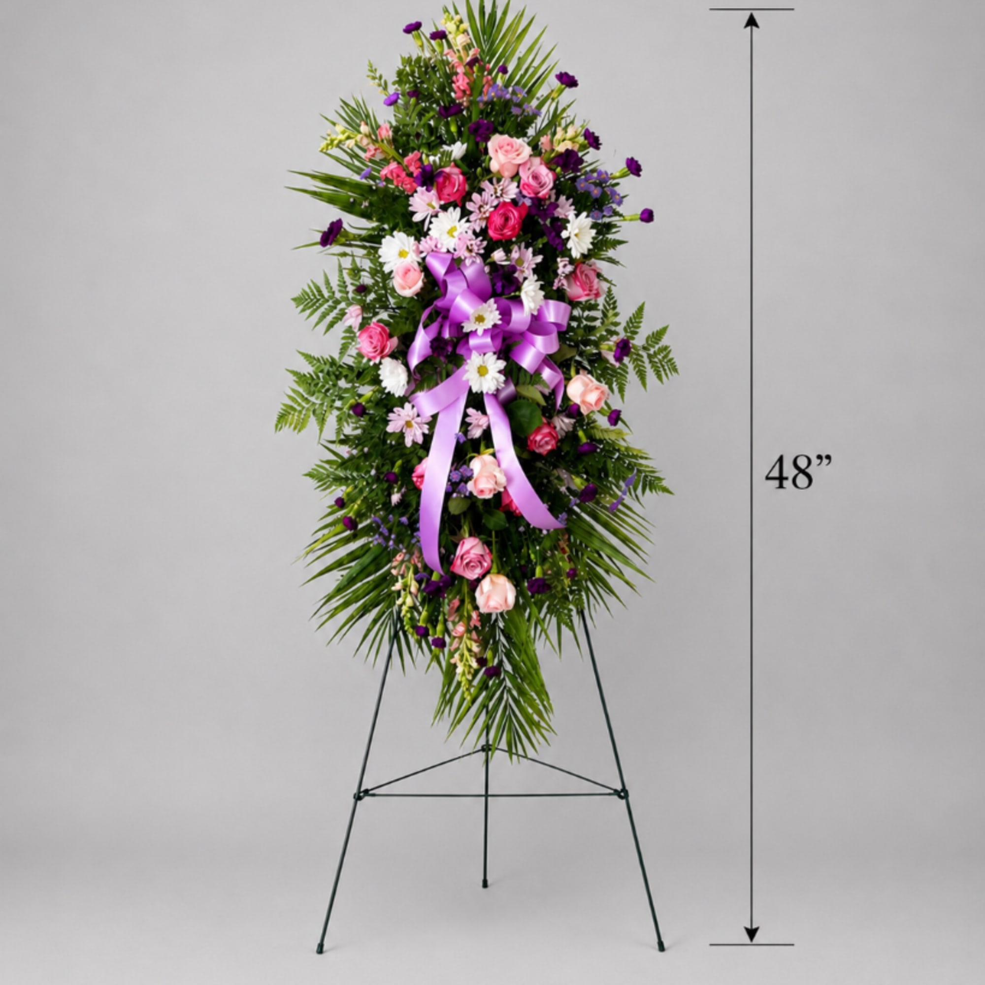 Tall floral standing spray with pink and purple flowers on a metal easel
