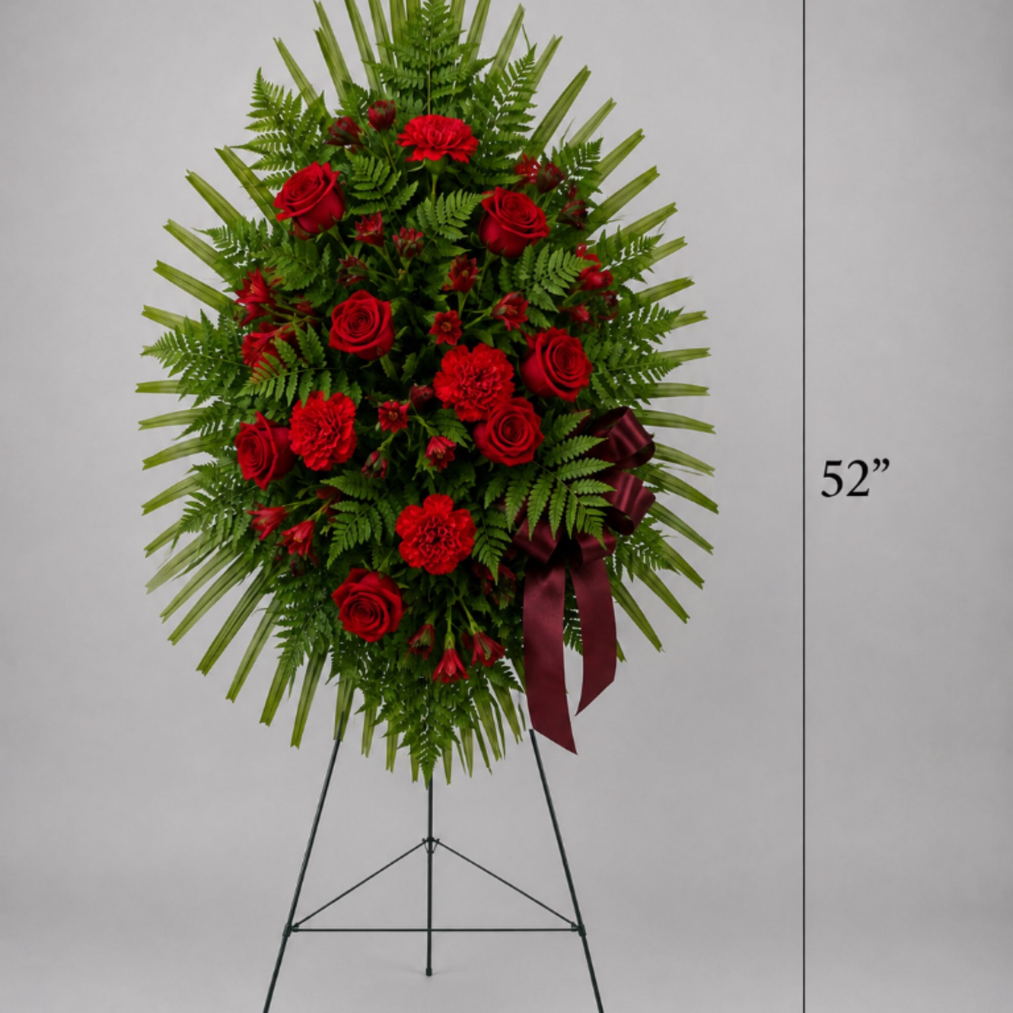 Tall red rose and carnation standing spray on a metal easel