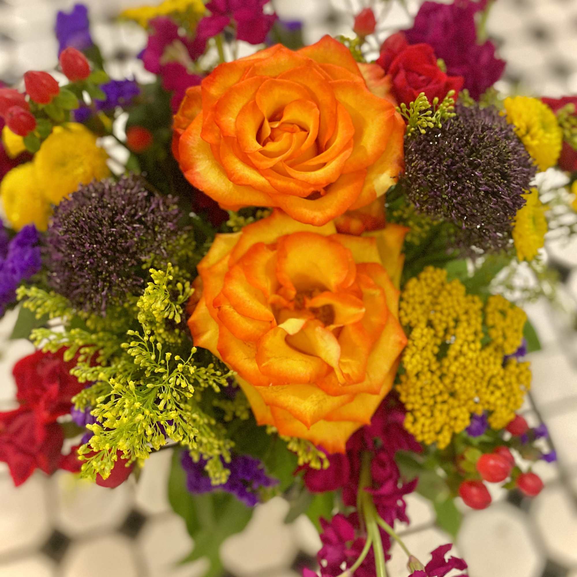 Bouquet with orange roses and colorful mixed flowers