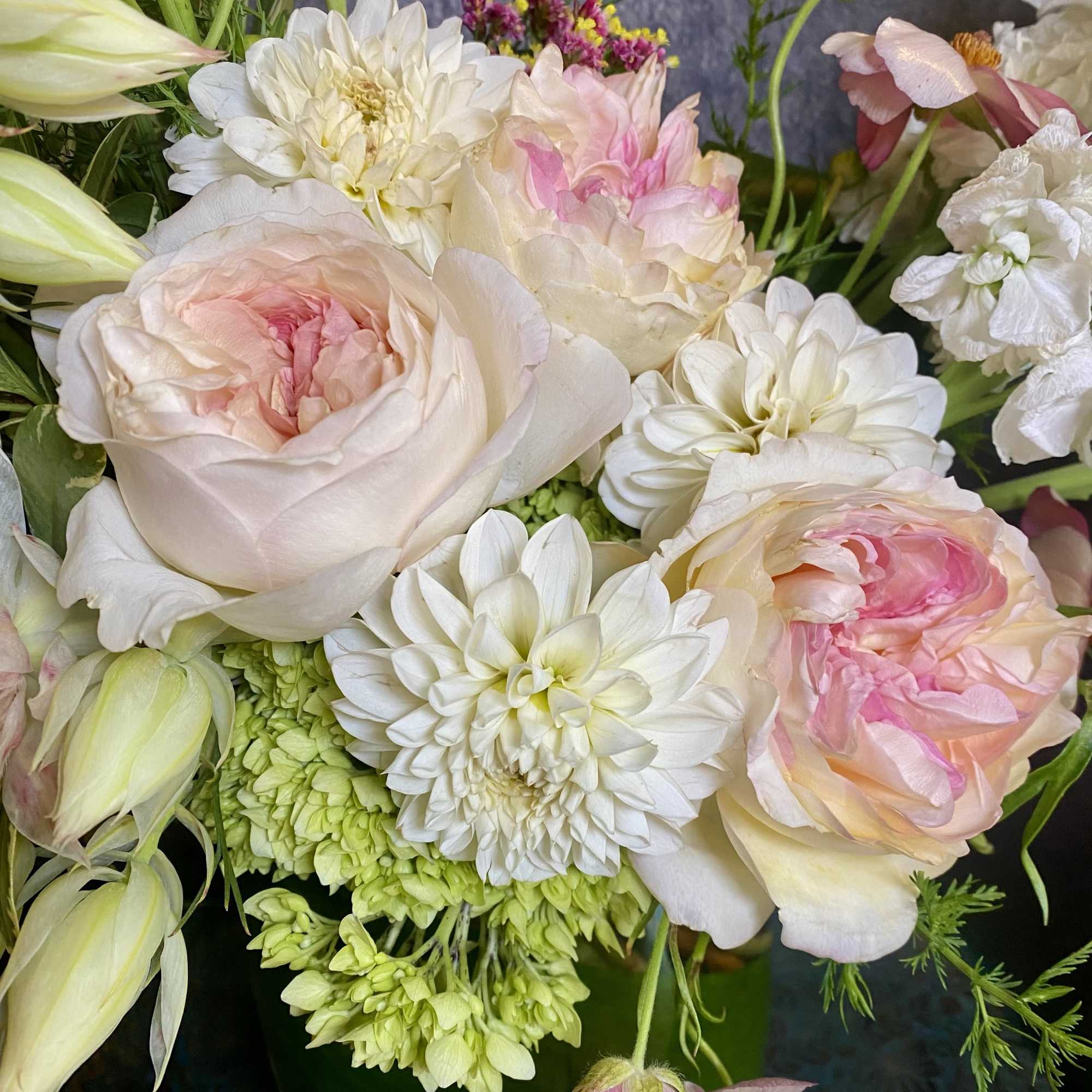 Bouquet of pale pink and white flowers with green accents