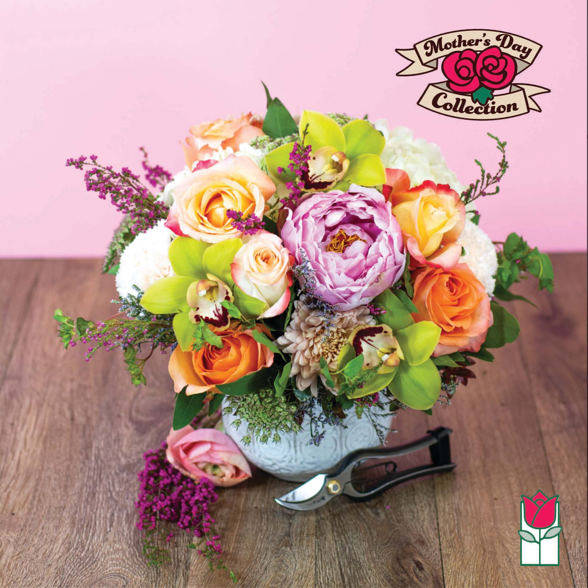 Mixed bouquet of roses, orchids, and a peony in a white vase