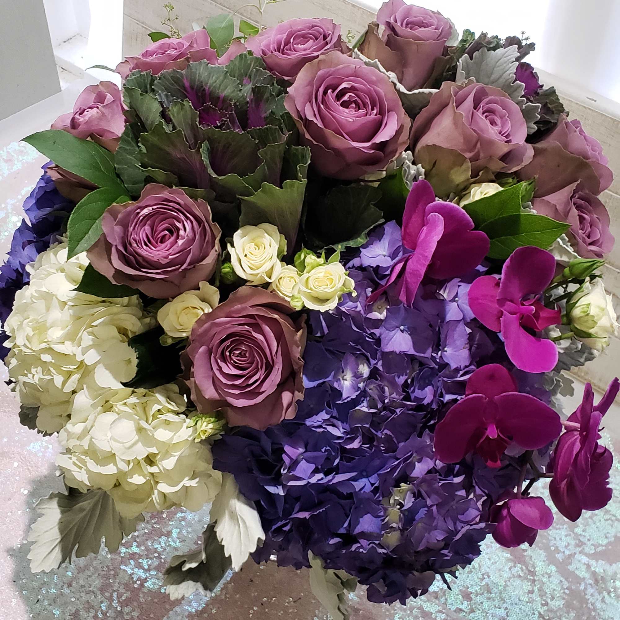 Bouquet of lavender roses, purple hydrangeas, and magenta orchids