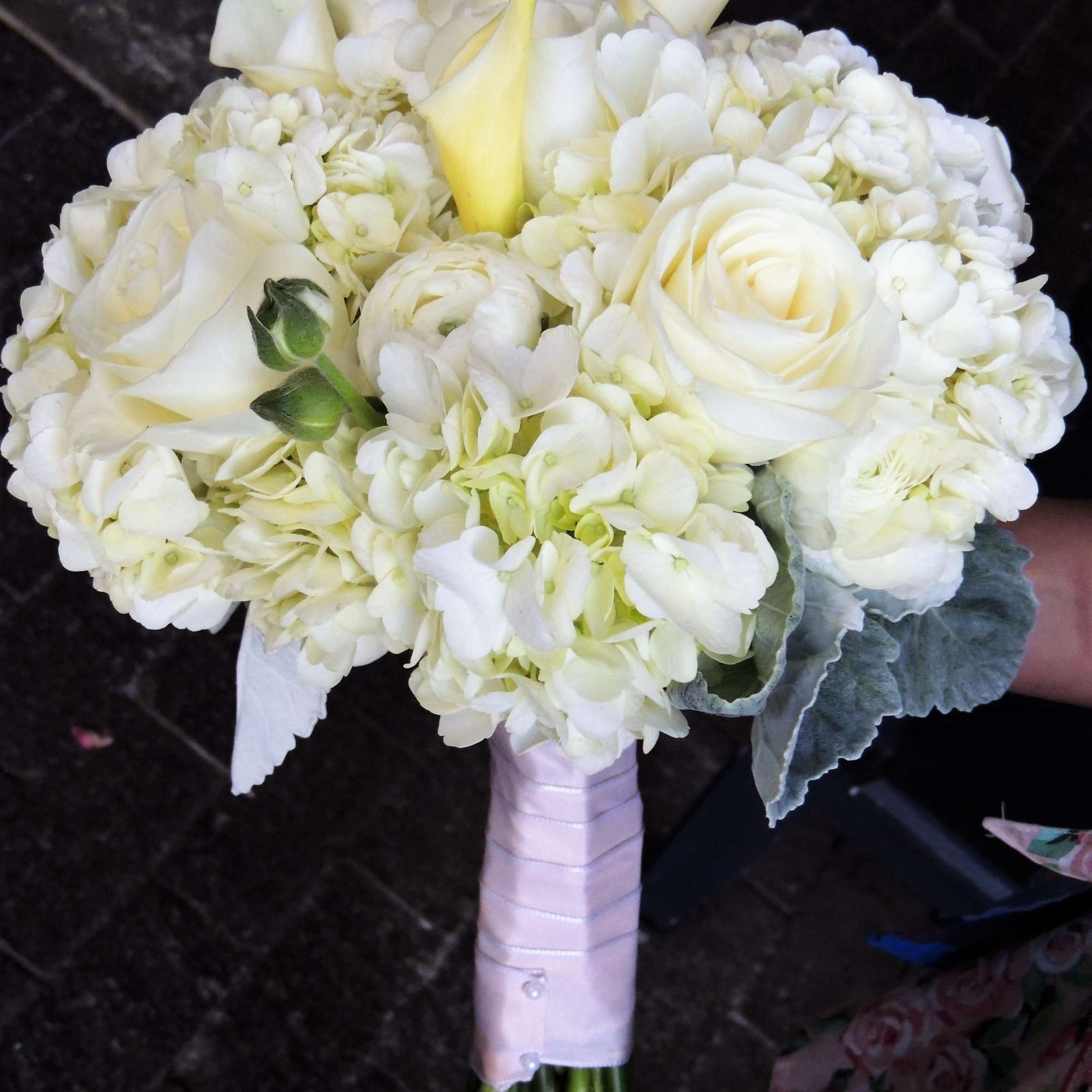 White rose and hydrangea bouquet with calla lilies and ribbon-wrapped stems