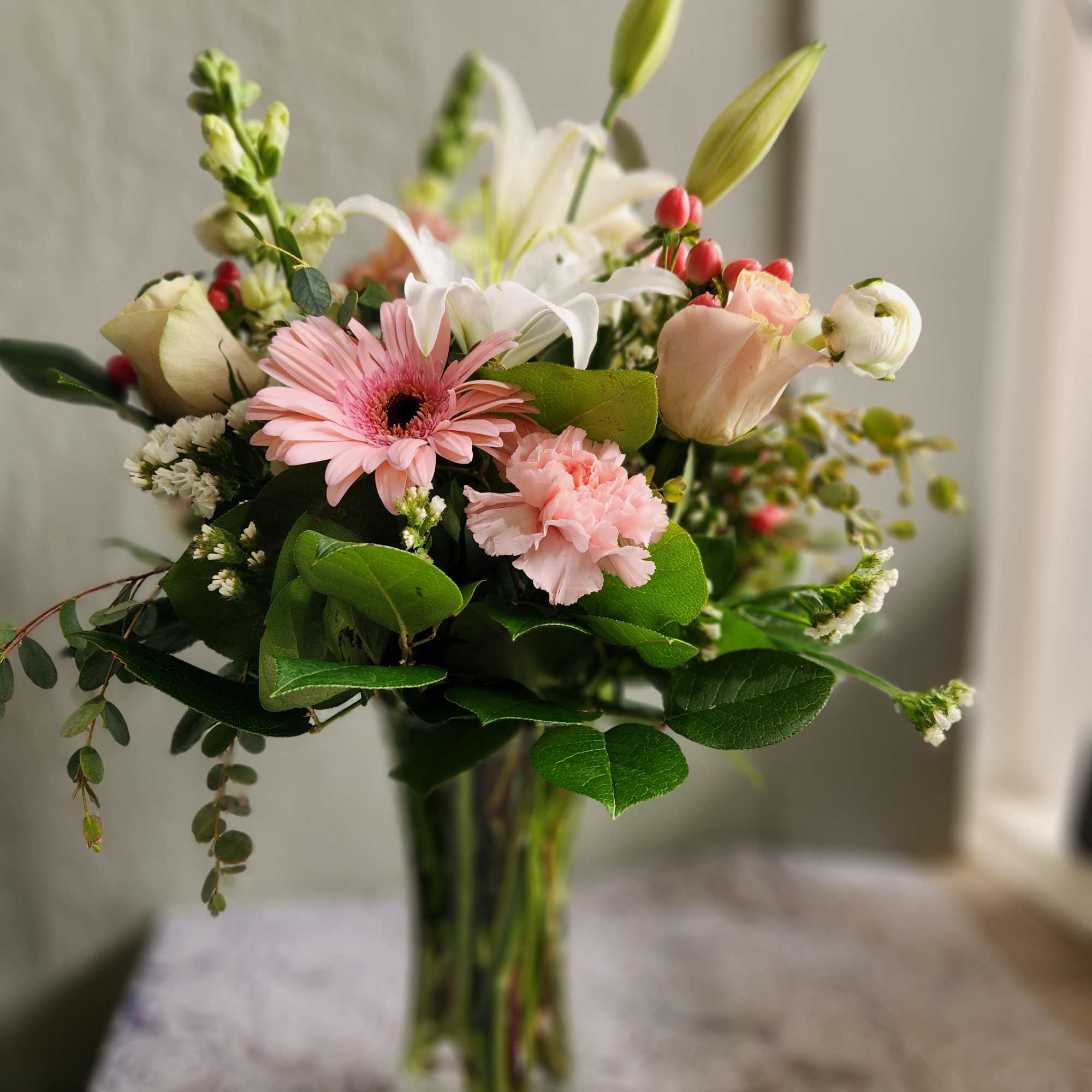 Pink and white mixed bouquet in a clear glass vase