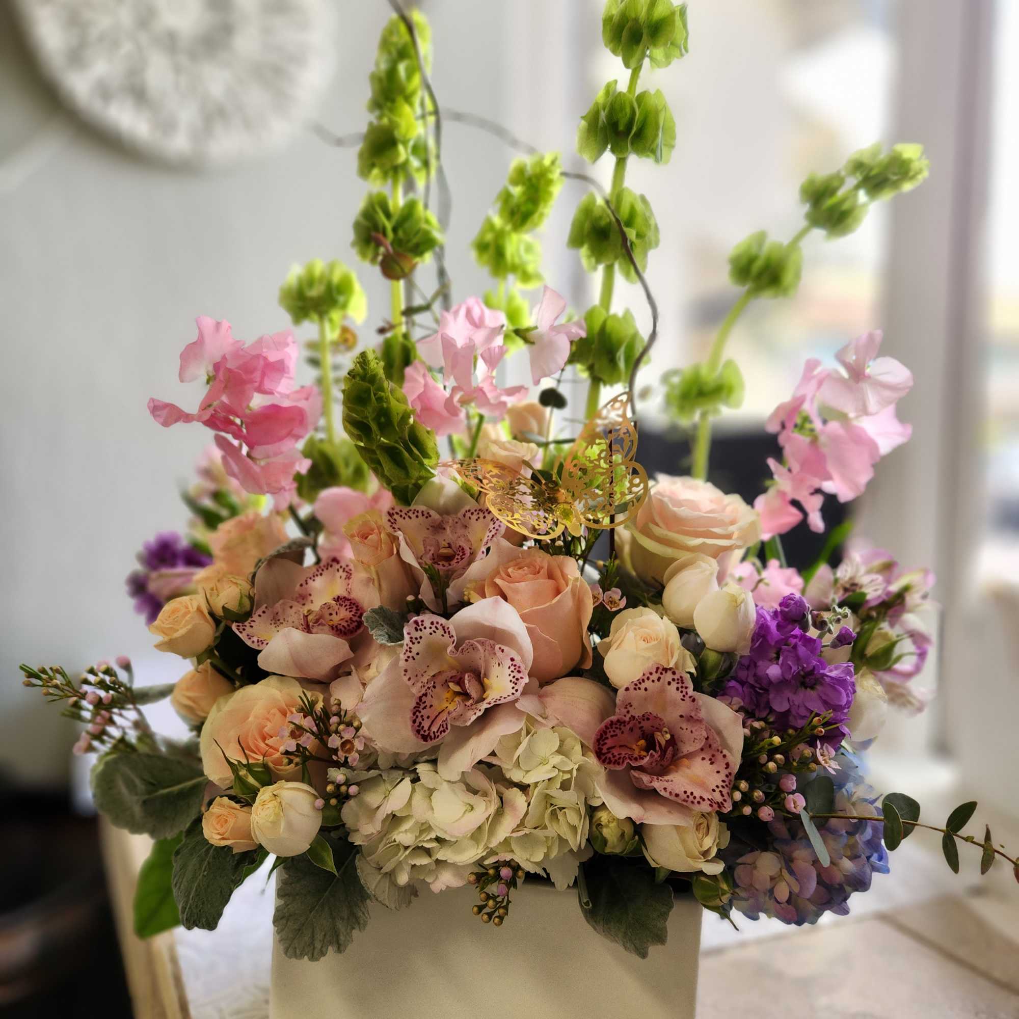 A vertical design with seasonal spring flowers in pastel mix Flowers may
