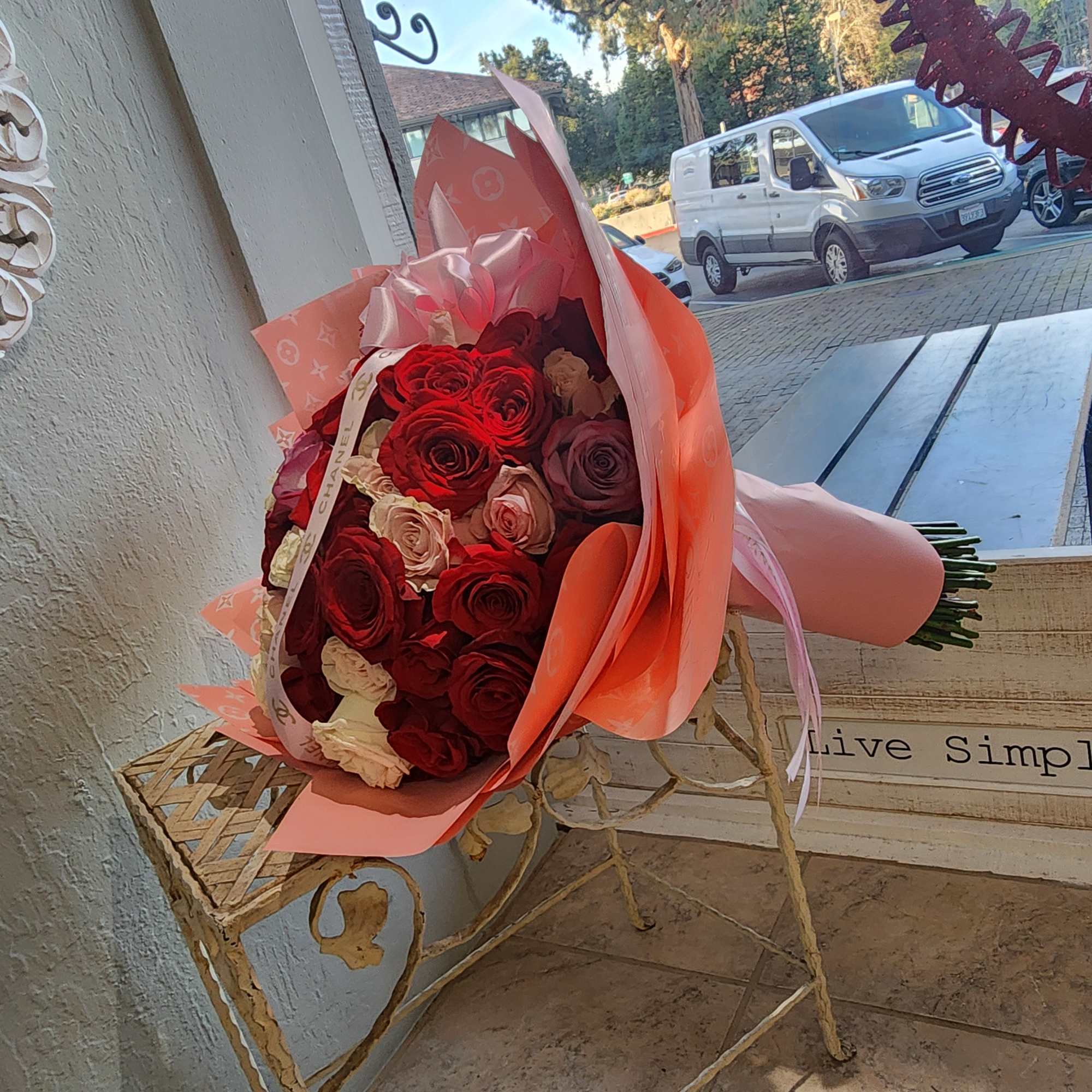 Bouquet of red and pink roses wrapped in peach paper