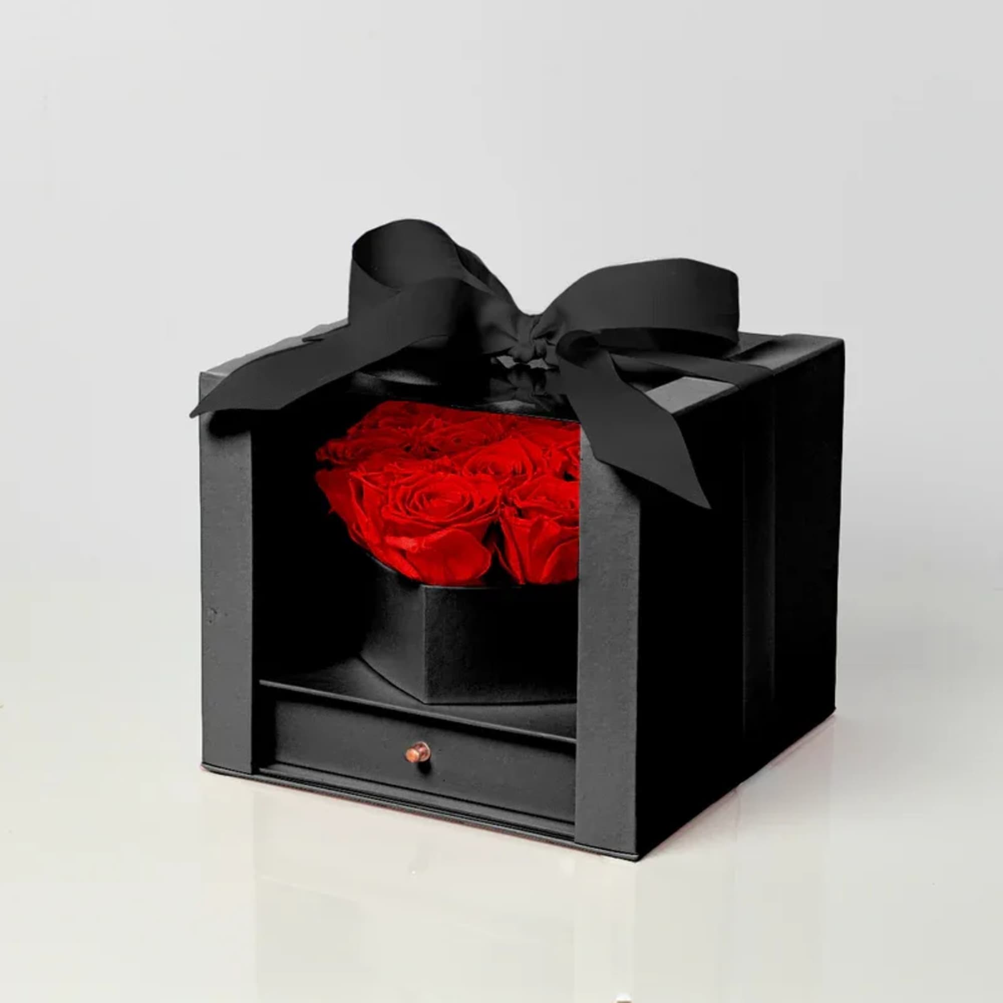 Black gift box with red roses and a large black ribbon bow