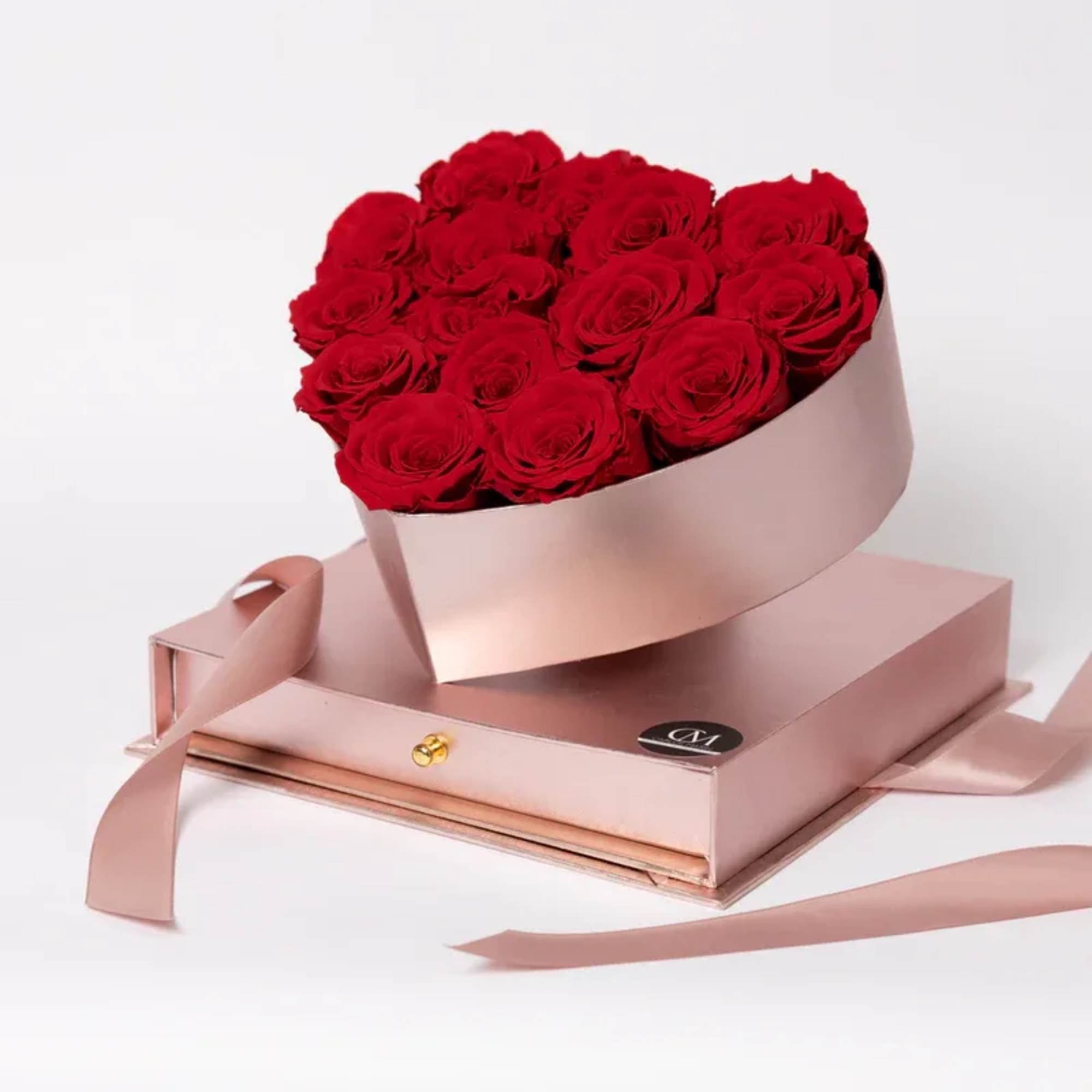 Bouquet of red roses in a pink box with ribbon