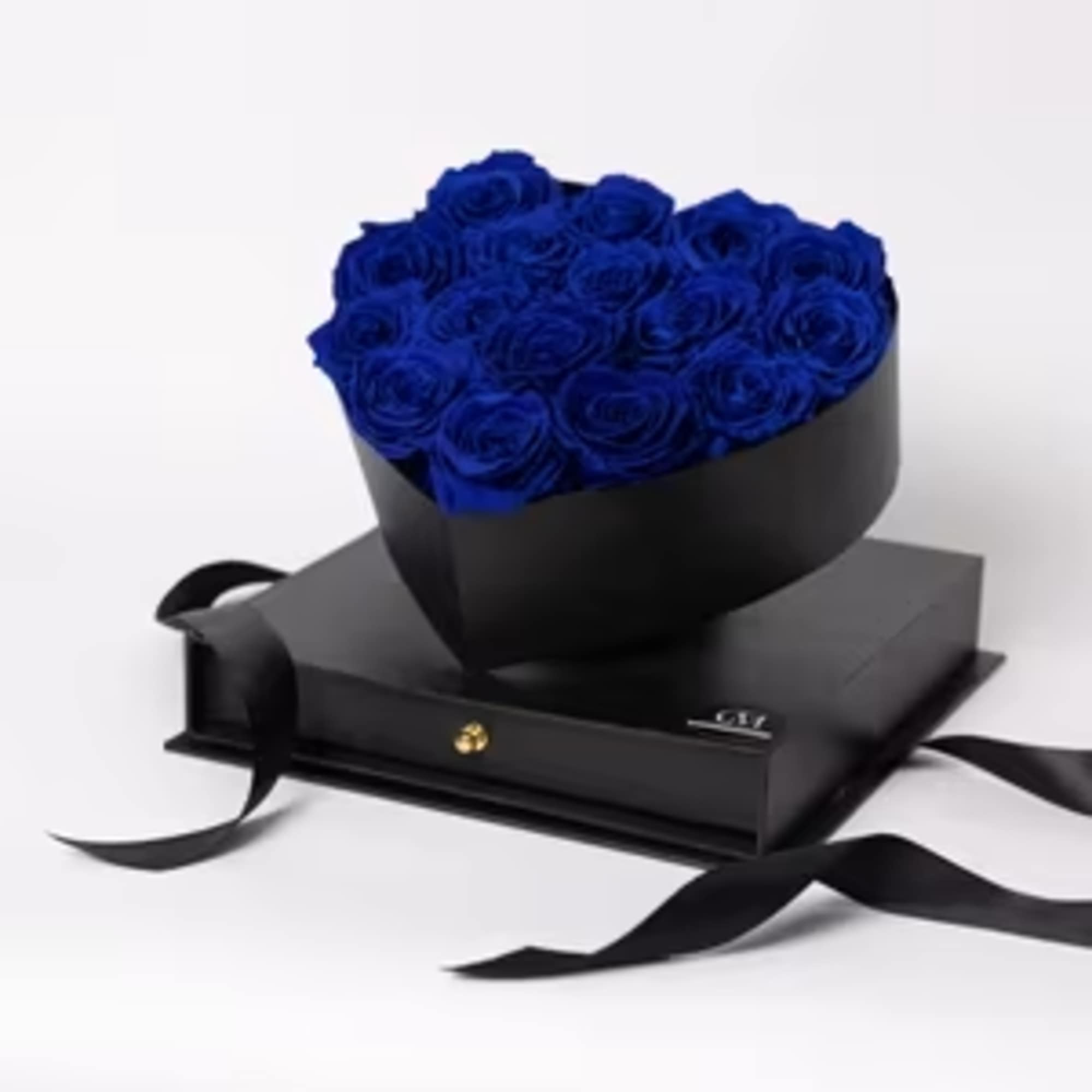 Heart-shaped bouquet of blue roses in a black box