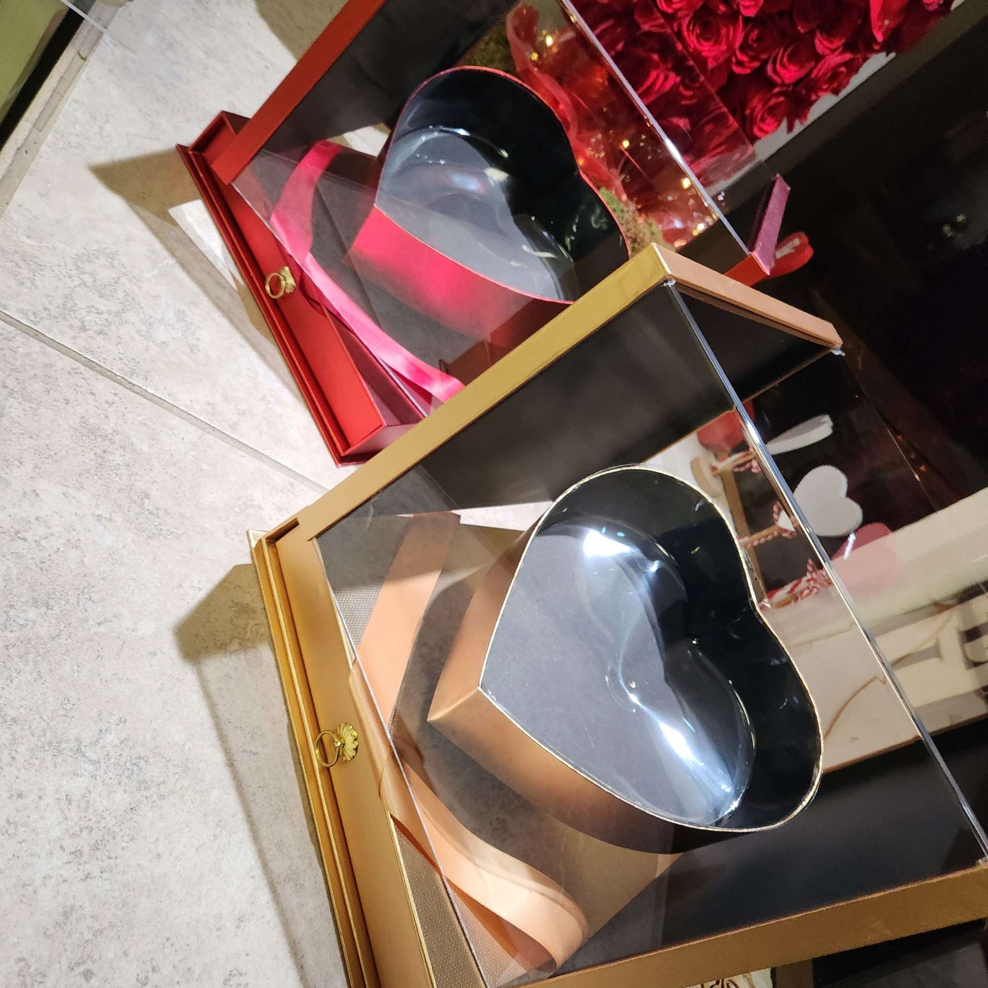 Heart-shaped gift boxes with clear lids and a red rose arrangement, photo 2 of 7