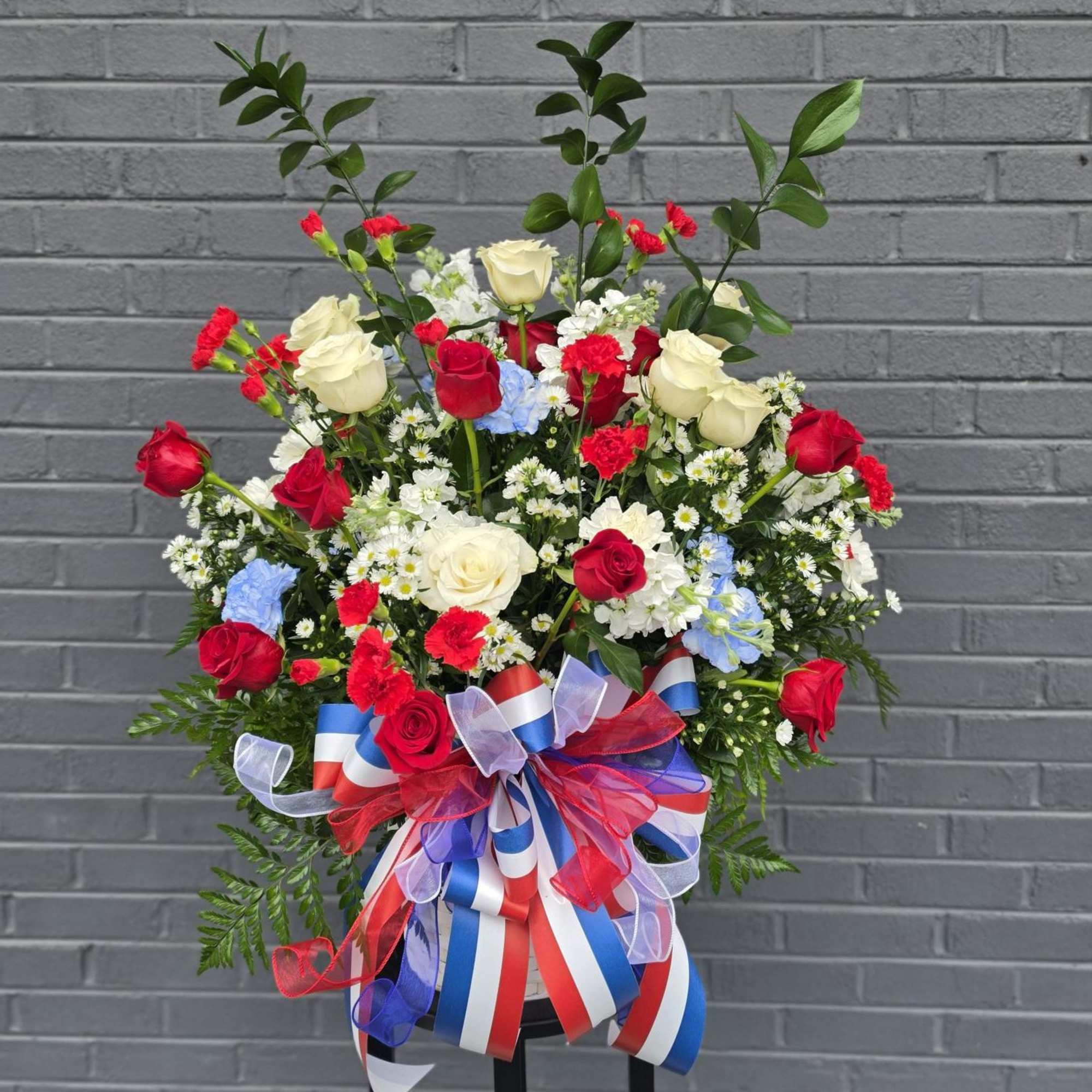 Bold, ceremonial and unmistakably patriotic, this standing flower arrangement is perfect as