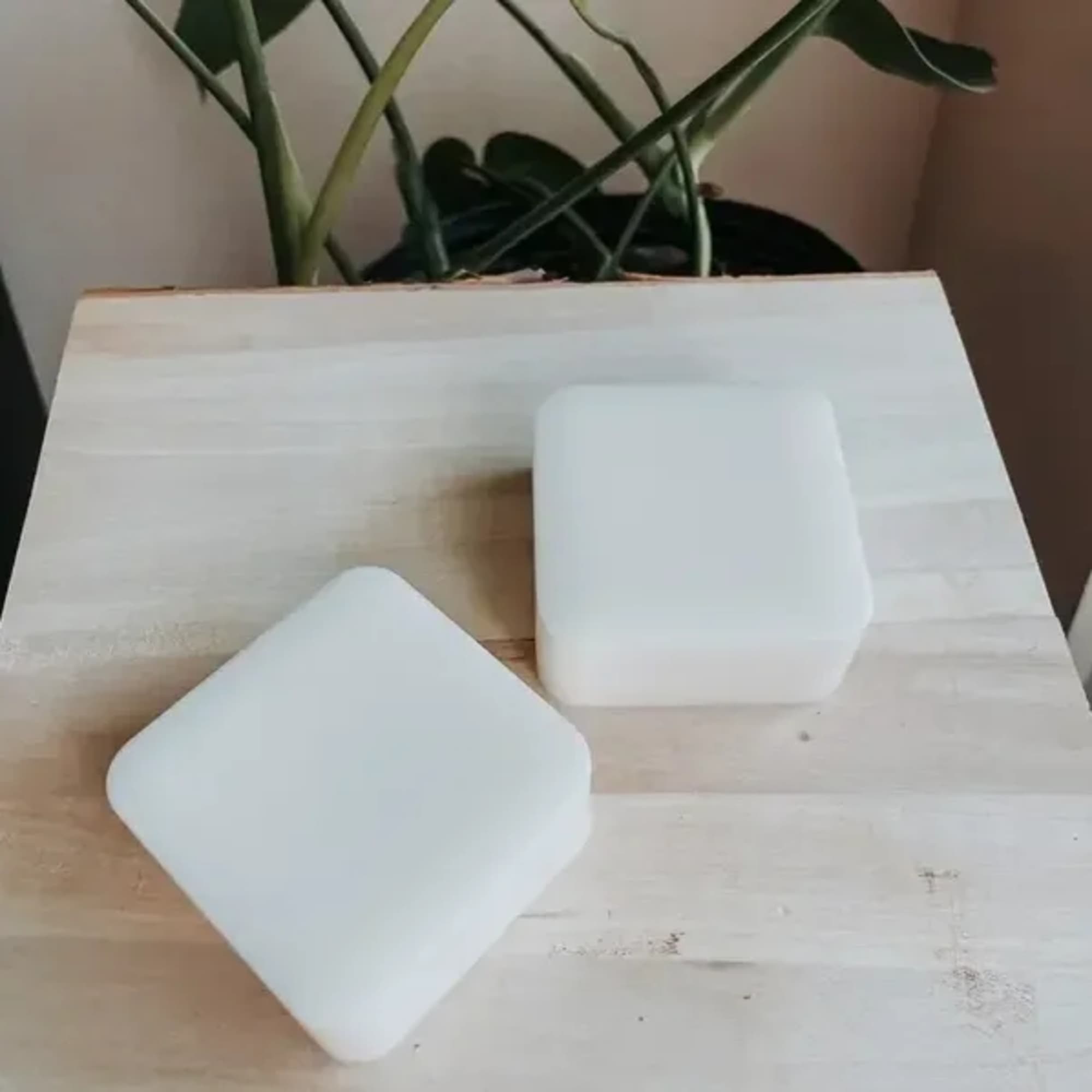 Two white foam blocks on a wooden surface