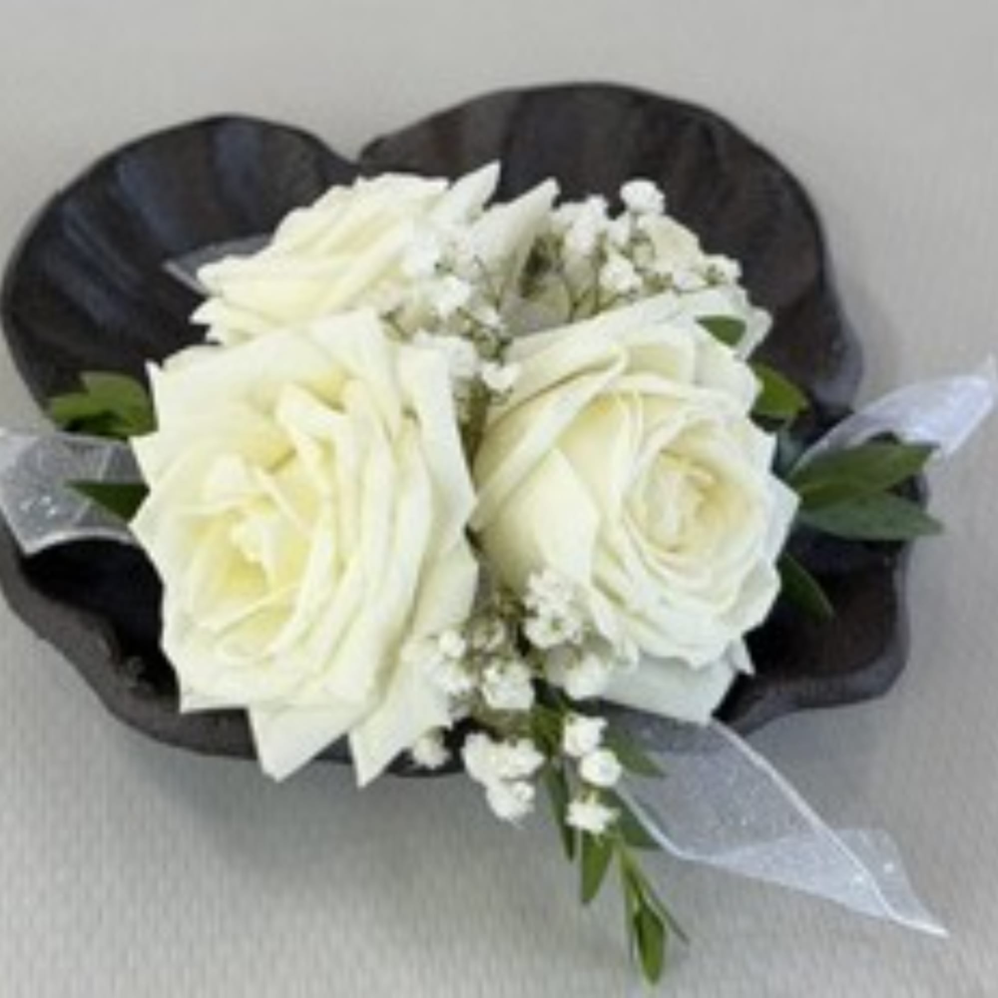 White rose boutonniere with baby's breath and black wrap