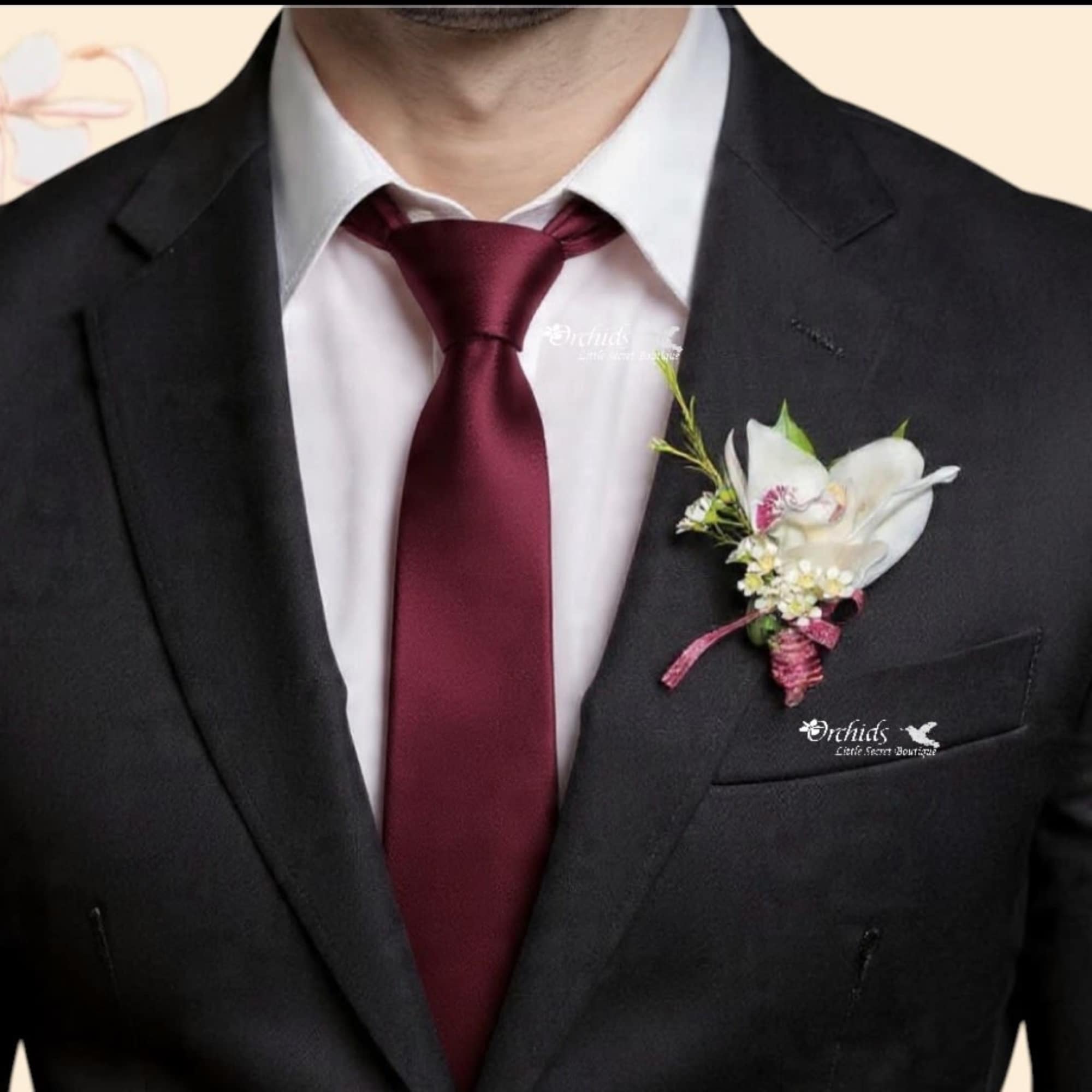 Make a lasting impression with this elegant exotic cymbidium orchid boutonniere, designed