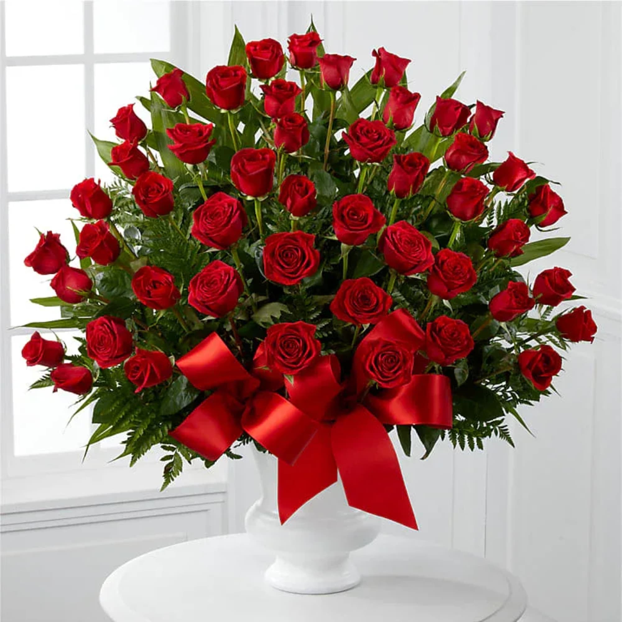A lush dome of deep red roses makes an immediate impression-the perfect