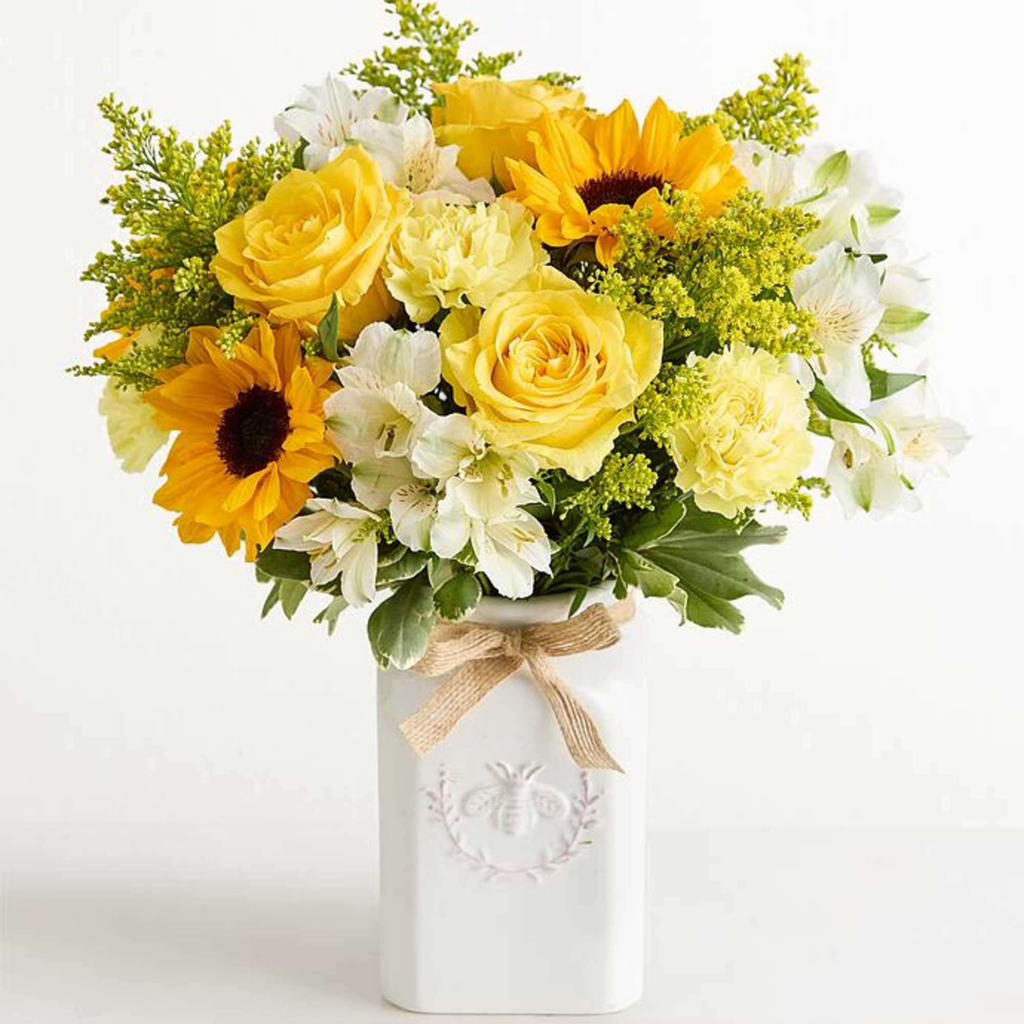 Bright, sunny yellow roses and bold sunflowers mingle with crisp white alstroemeria