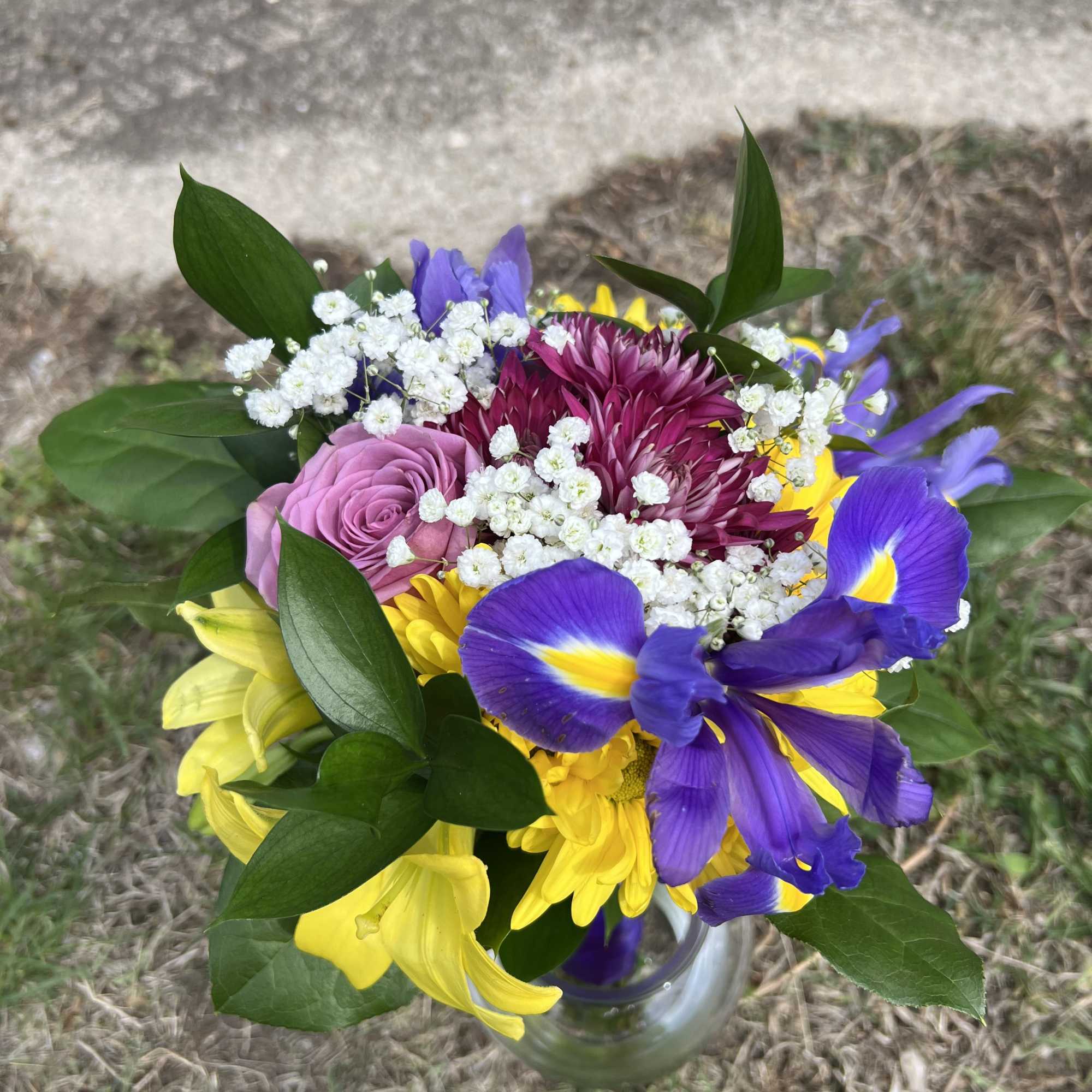 An elegant and colorful hand-tied bouquet that will compliment any prom outfit.