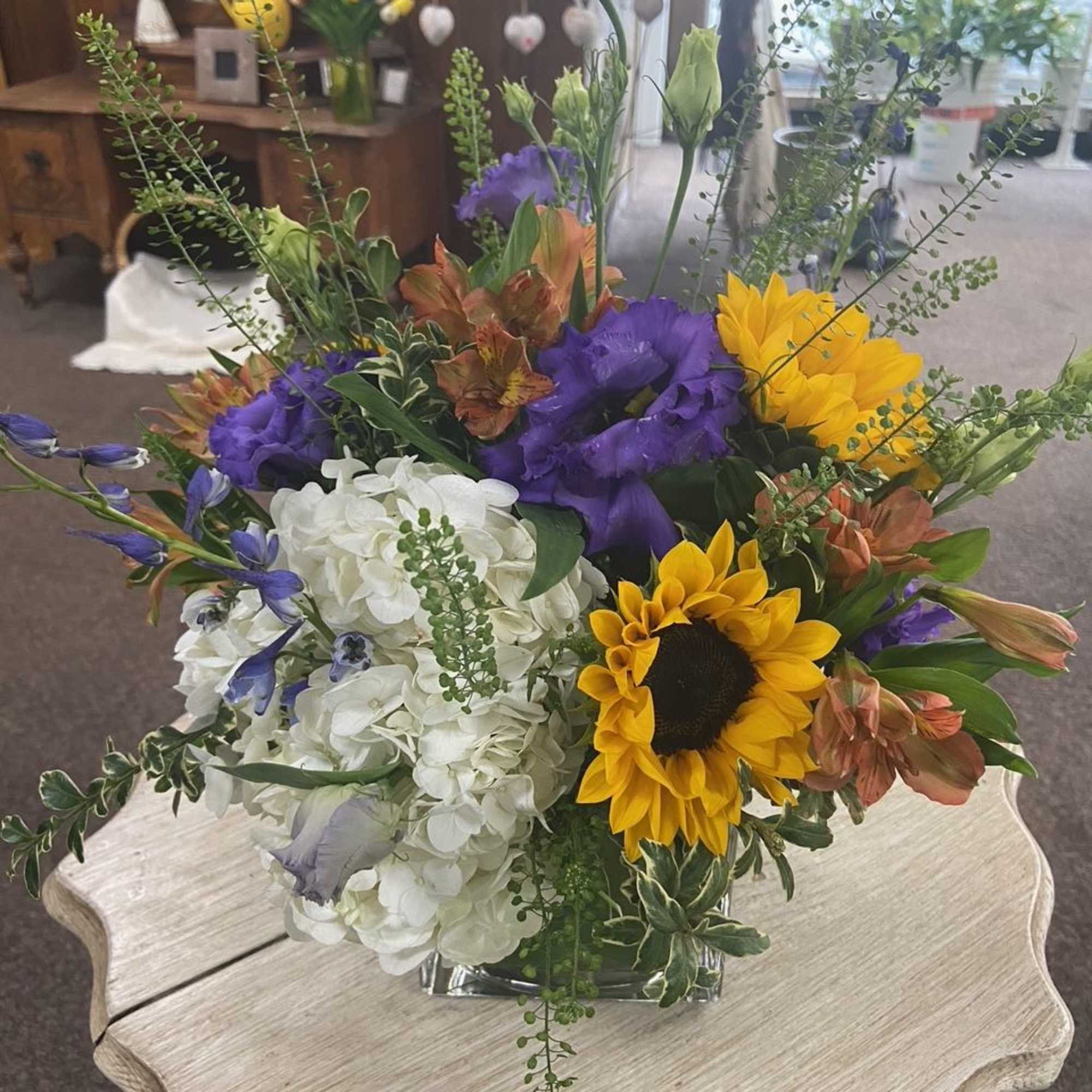 Sweetness roses, purple lisianthus, fluffy white hydrangeas, piercing blue delphinium, and yellow, photo 2 of 2