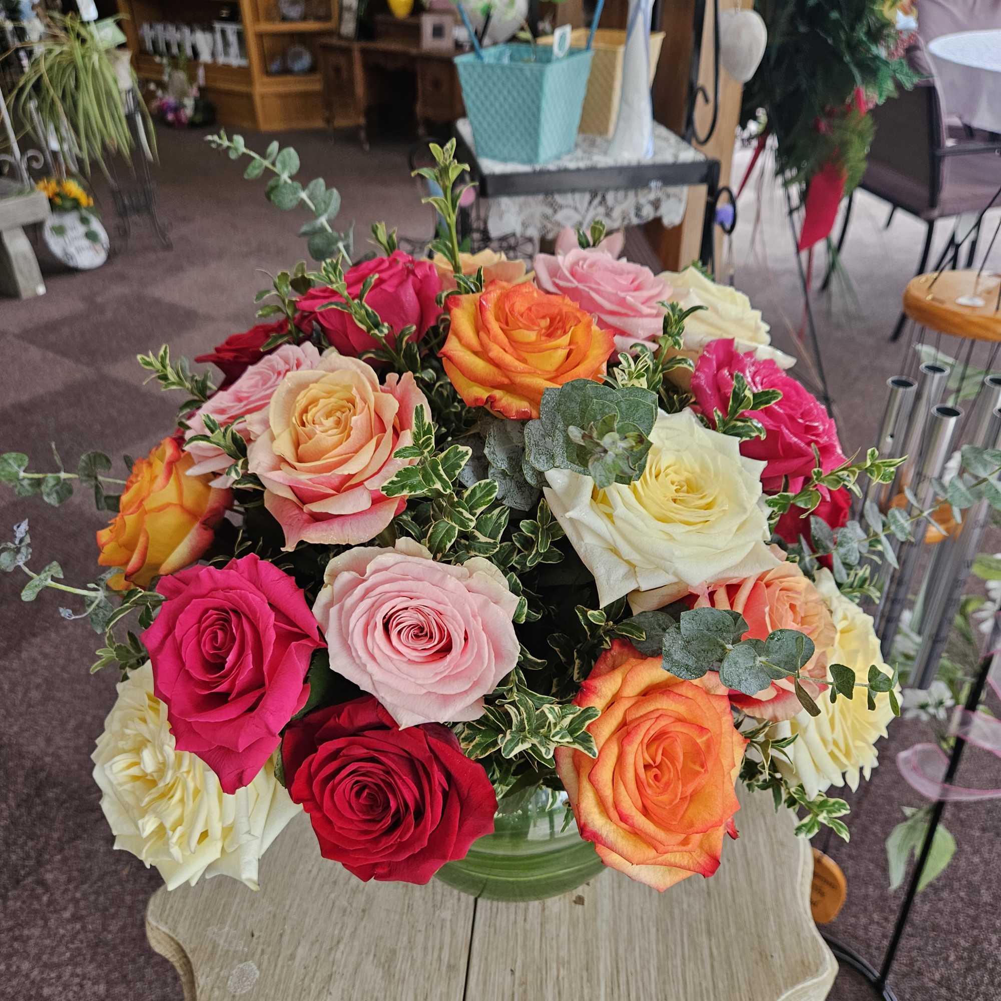Mixed roses in a glass vase on a table