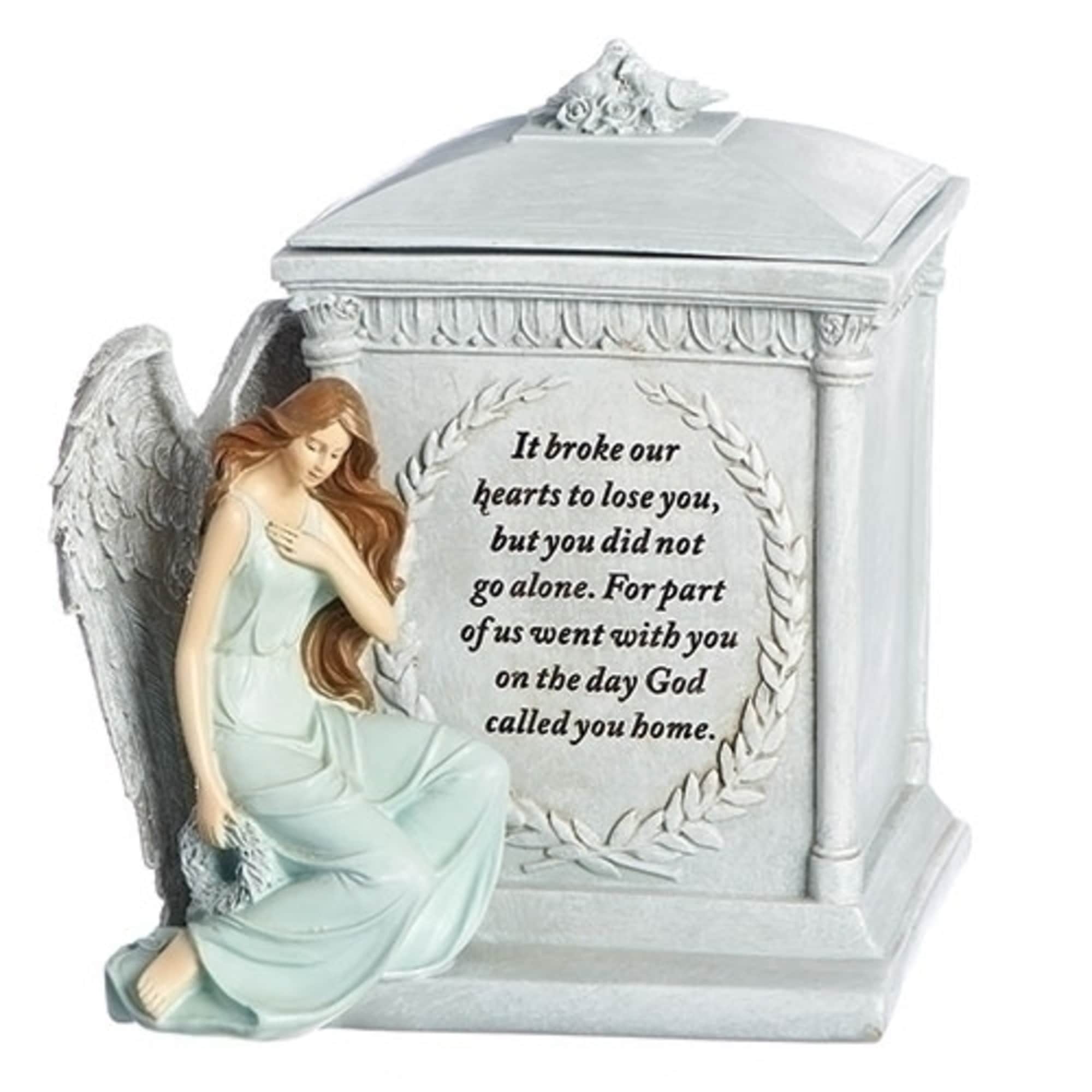 Angel figurine beside a memorial urn with a sympathy message