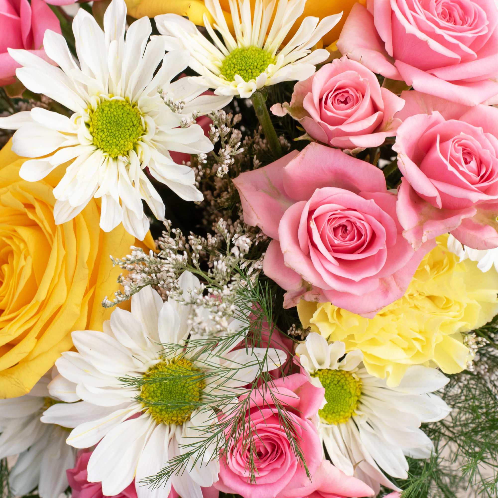 Bouquet of pink roses, white daisies, and yellow flowers