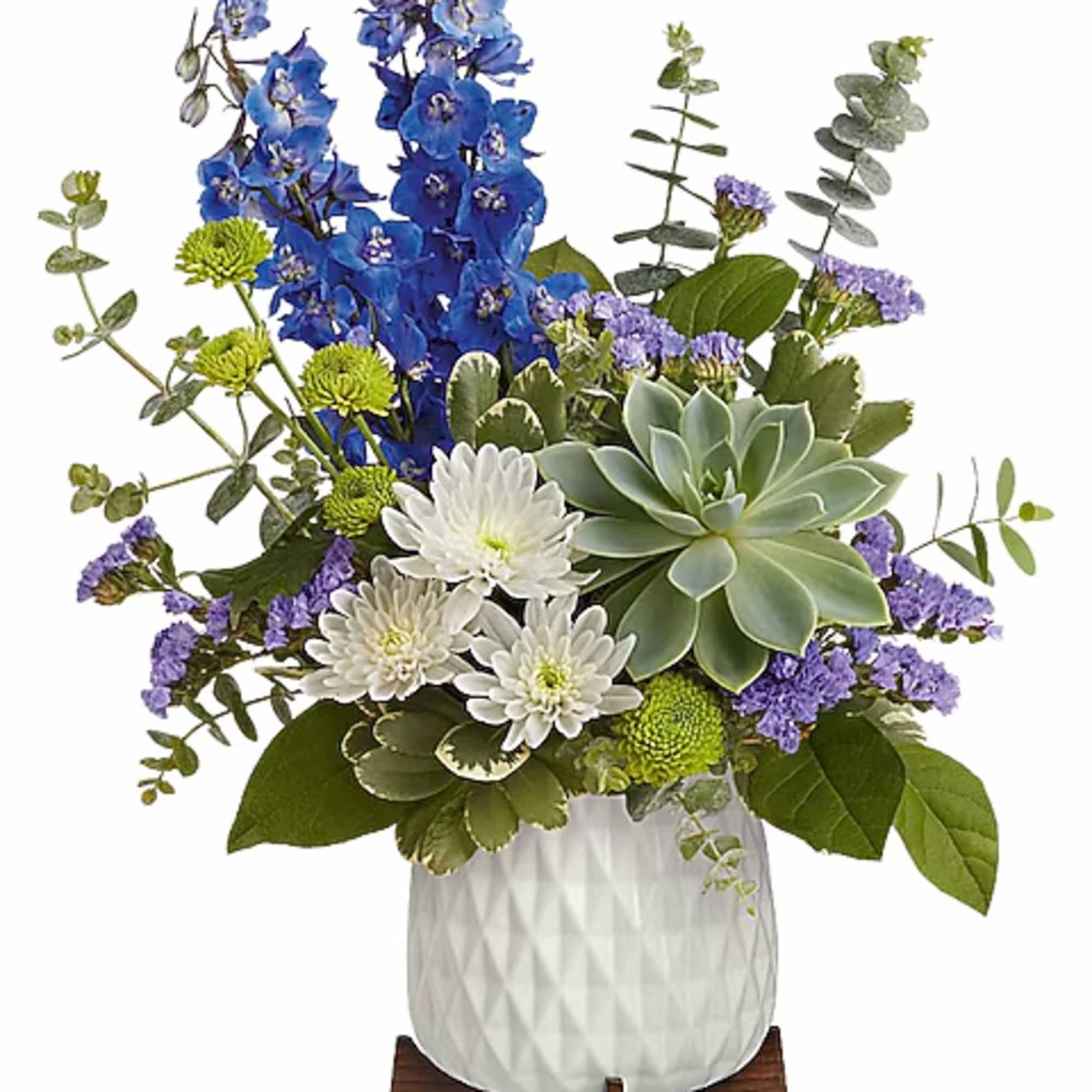 Blue and white floral arrangement with a succulent in a white vase