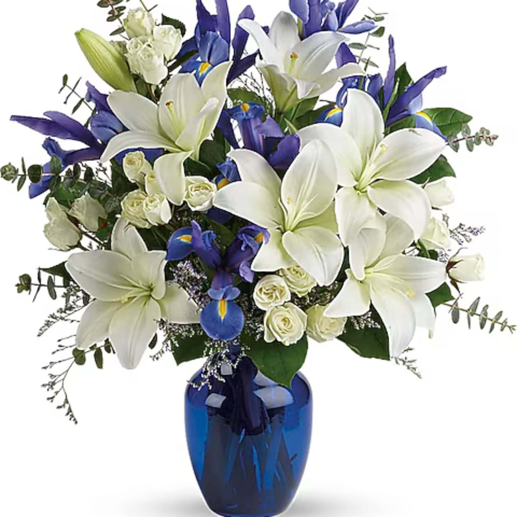 White lilies and blue irises in a cobalt vase