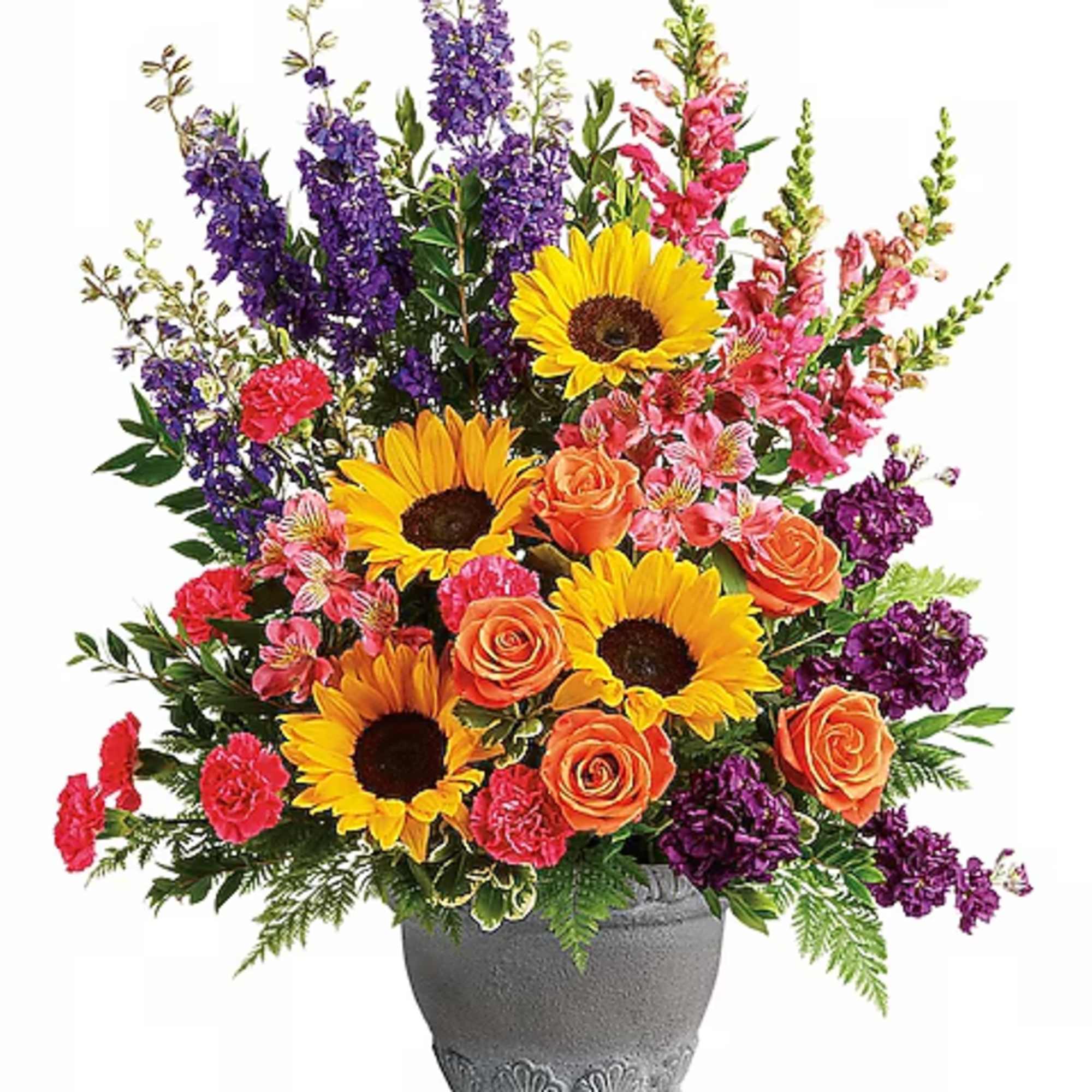 Colorful bouquet with sunflowers, roses, and purple spikes in a gray vase
