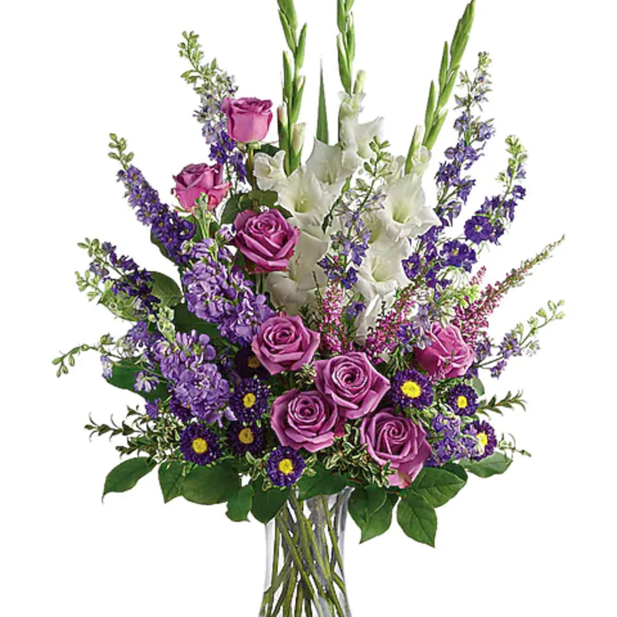 Purple roses and white gladiolus in a clear glass vase