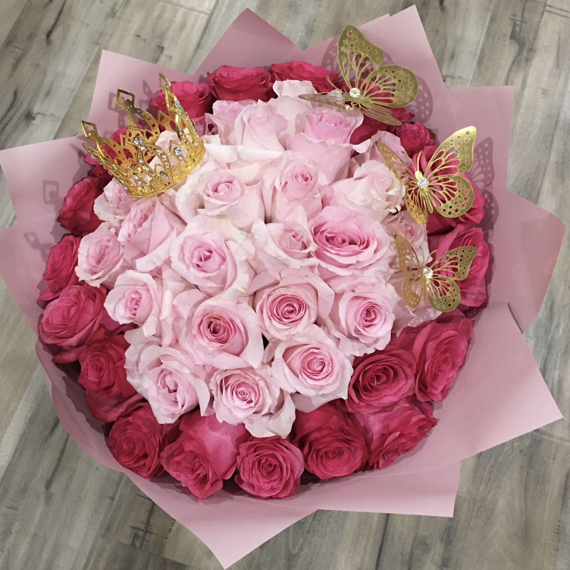 Pink and red rose bouquet with gold crown and butterfly picks
