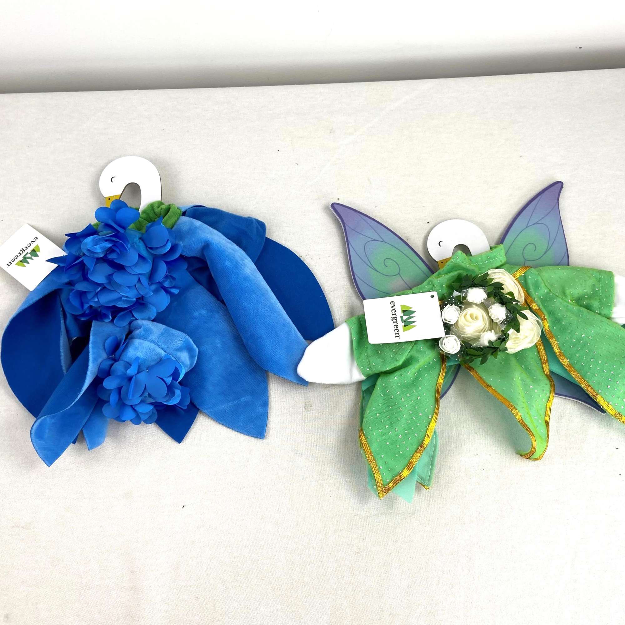 Two floral fairy costumes with blue and green fabric petals and small flower accents