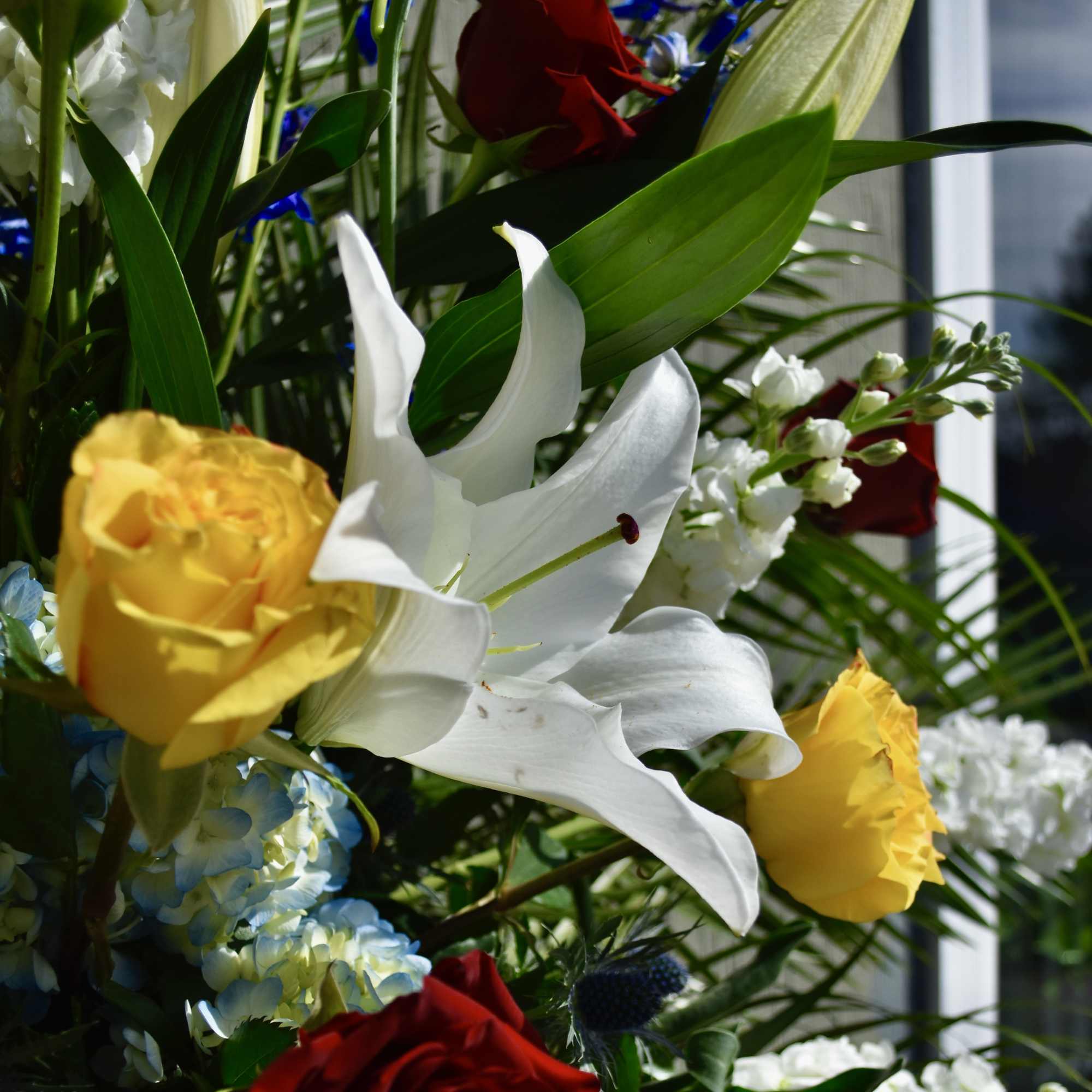 Mixed bouquet with red and yellow roses and white lilies