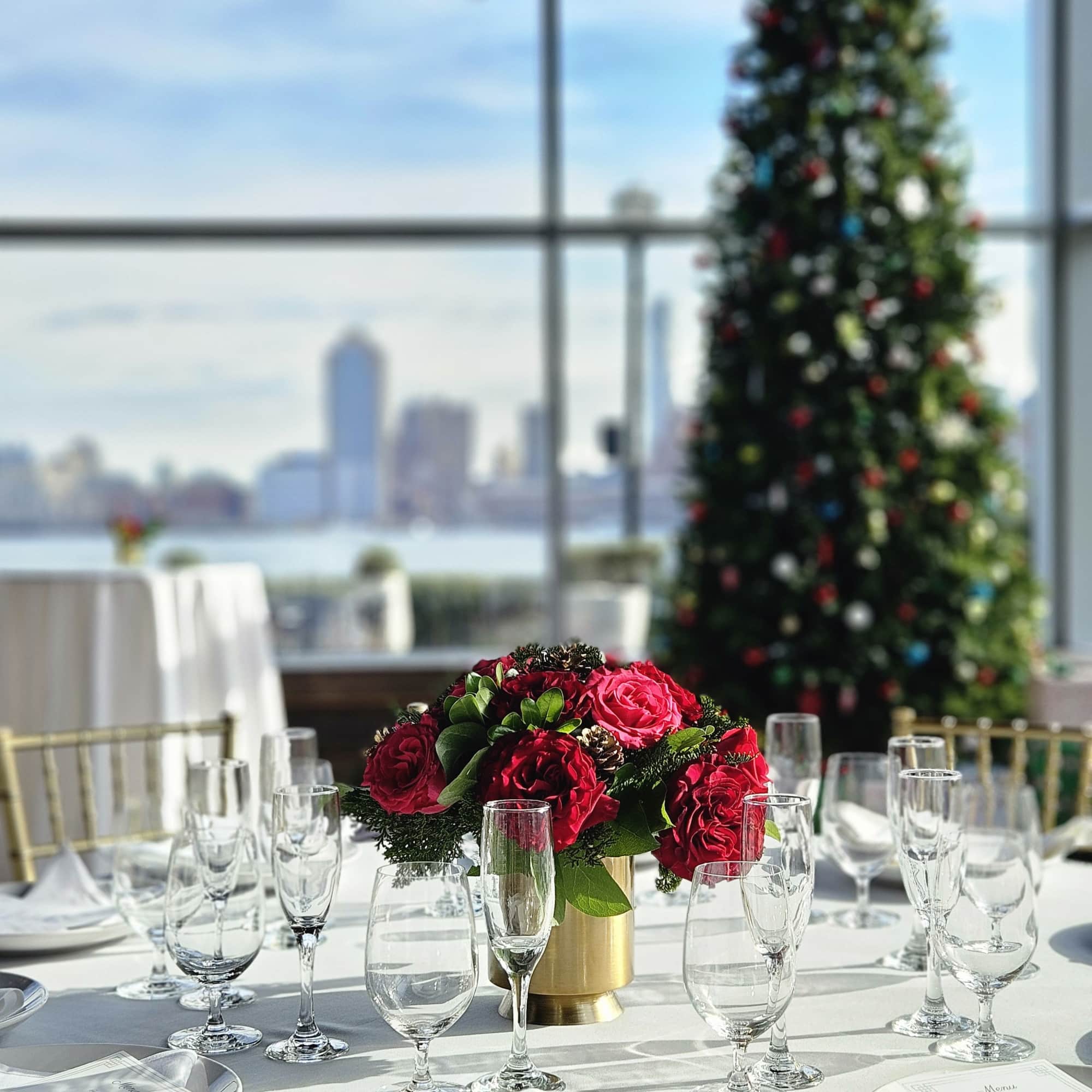 Red rose centerpiece in a gold vase on a set dining table, photo 2 of 2