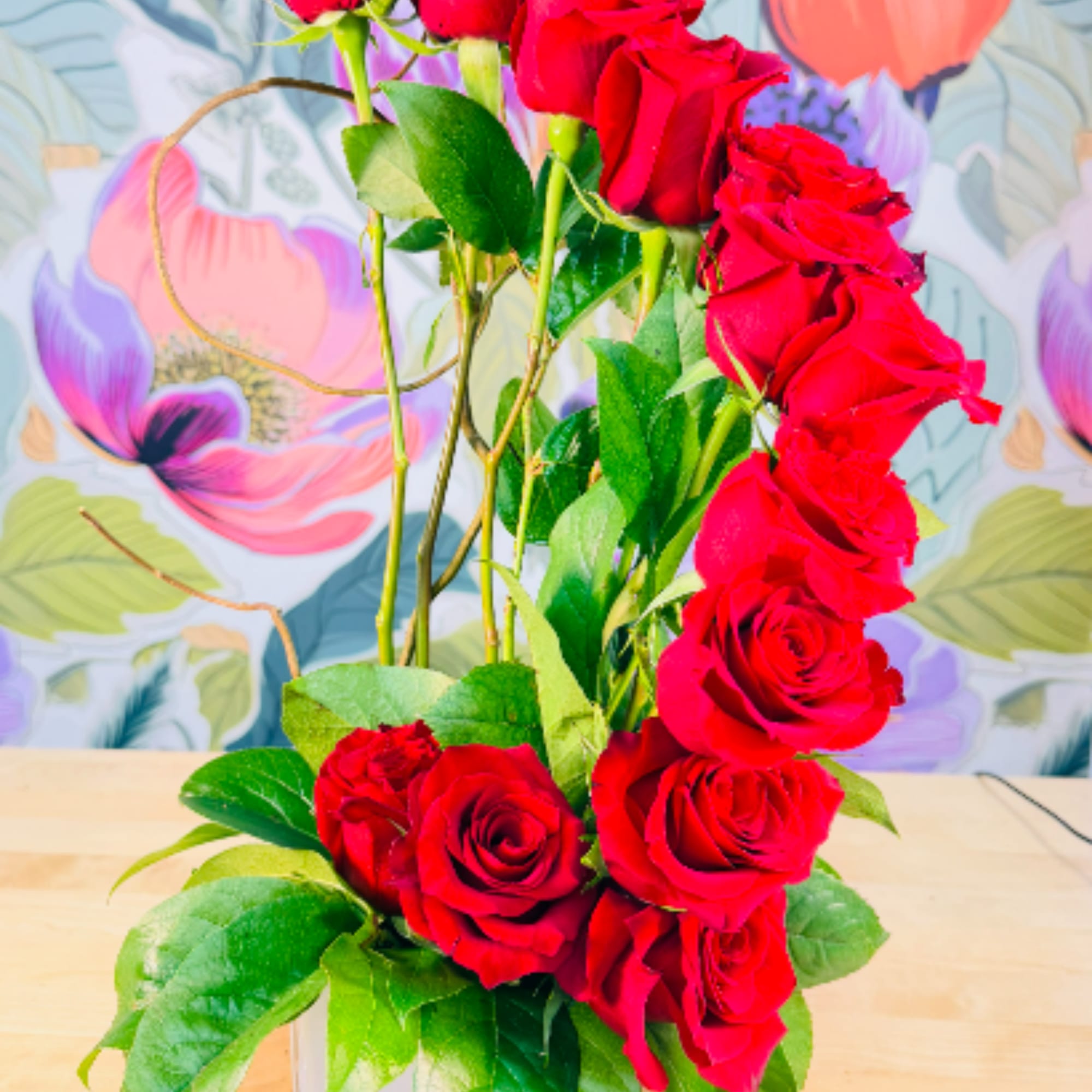 A dramatic column of vivid red roses draws the eye upward in