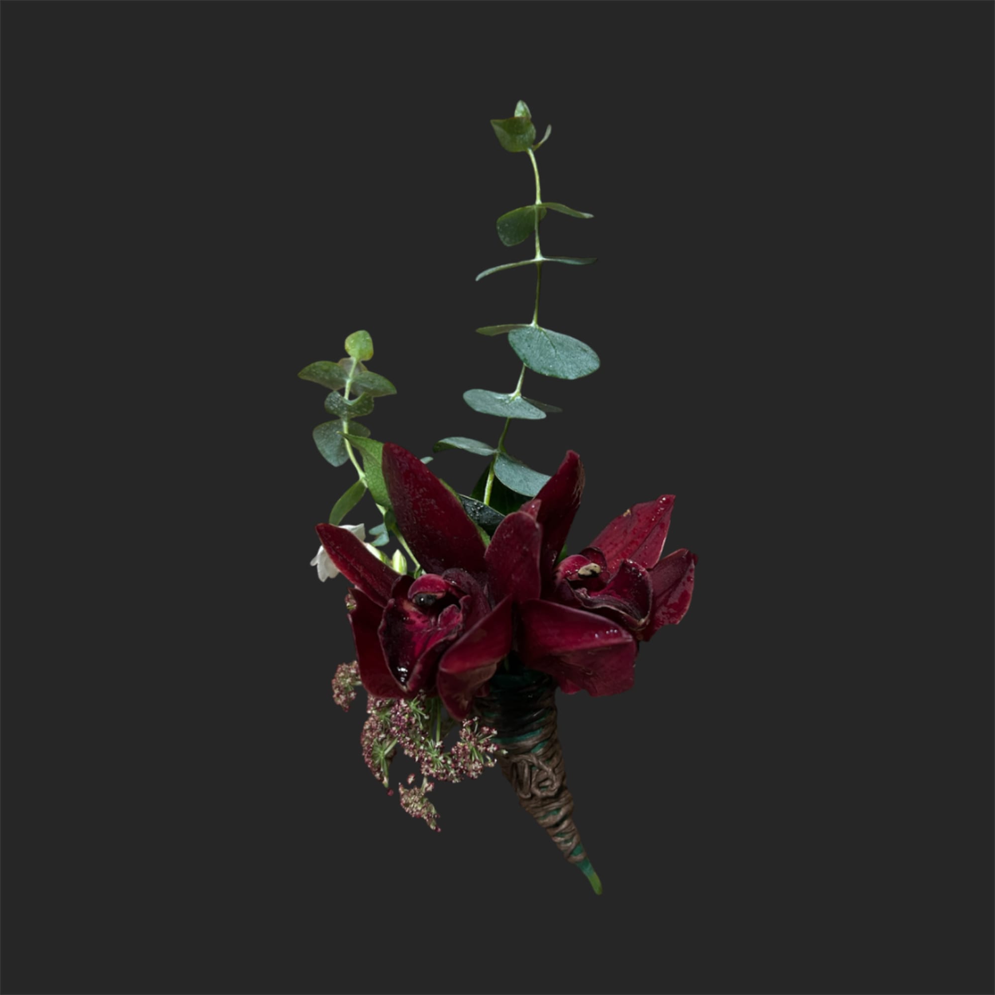 Small burgundy floral boutonniere with eucalyptus on a dark background