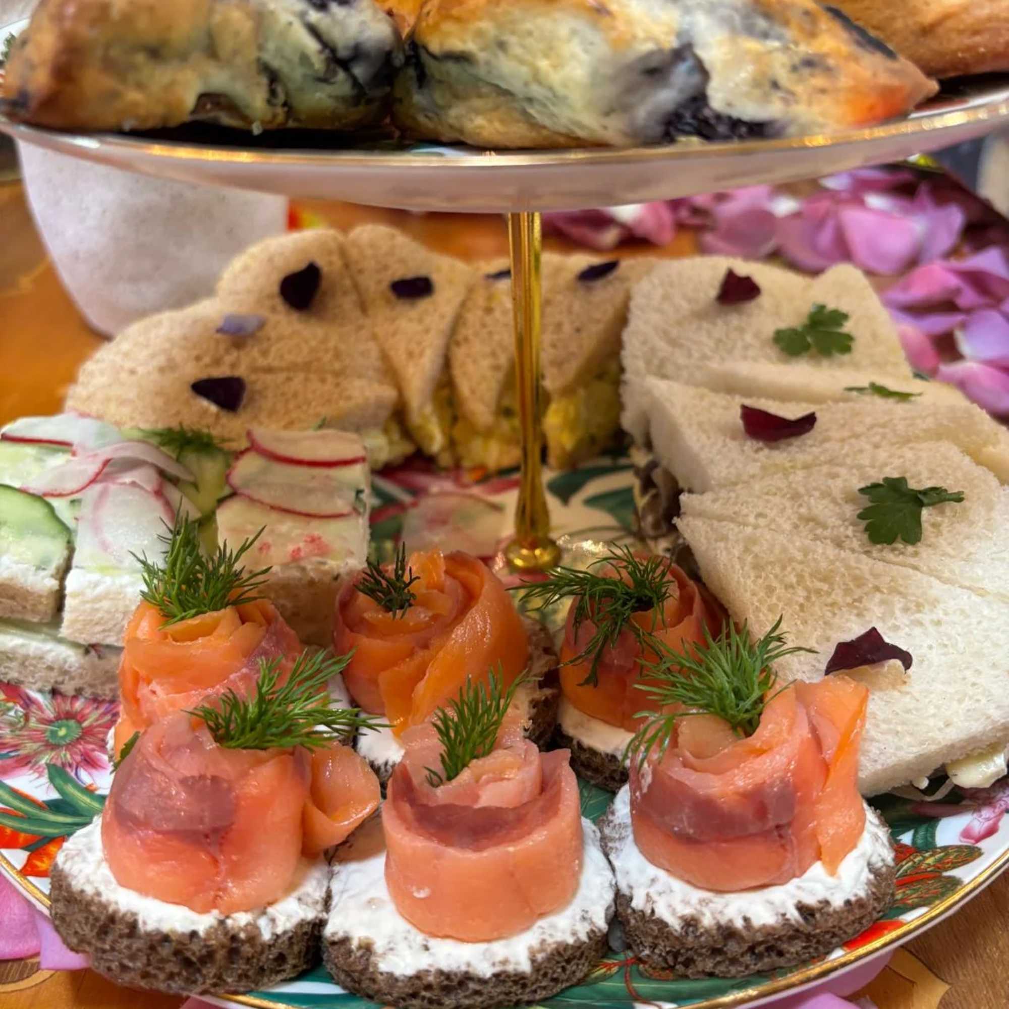 Tiered tray of tea sandwiches and smoked salmon canapés