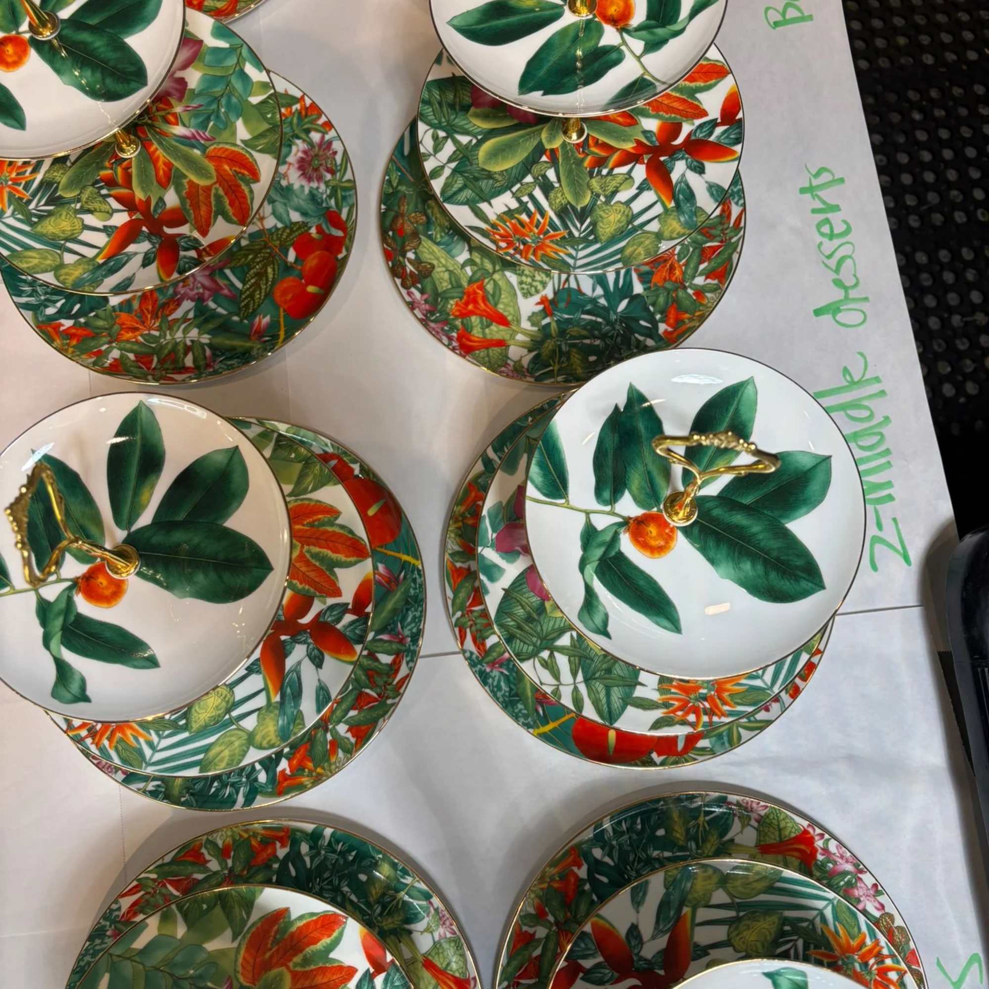 Stacked decorative plates with tropical leaf and flower patterns
