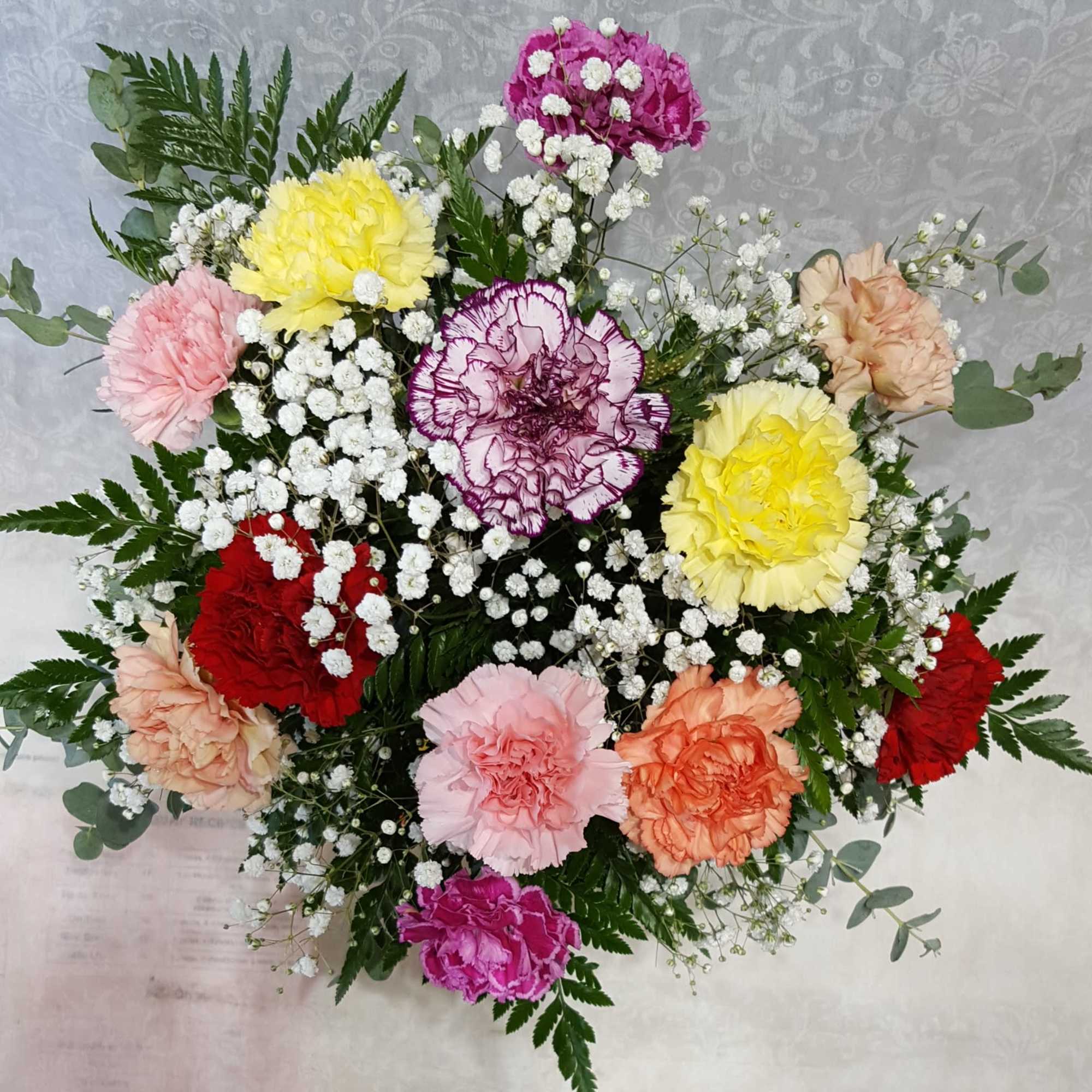 Colorful bouquet of carnations with baby's breath and greenery