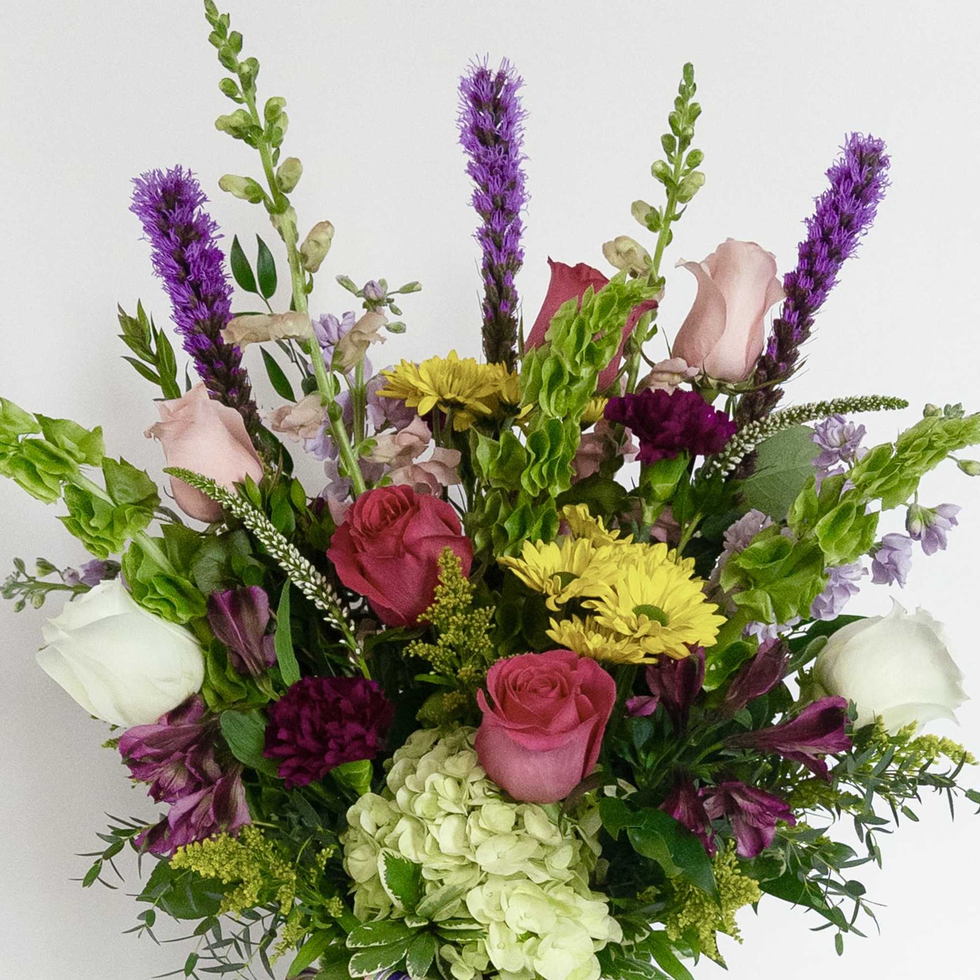 Mixed bouquet with pink, white, yellow, and purple flowers