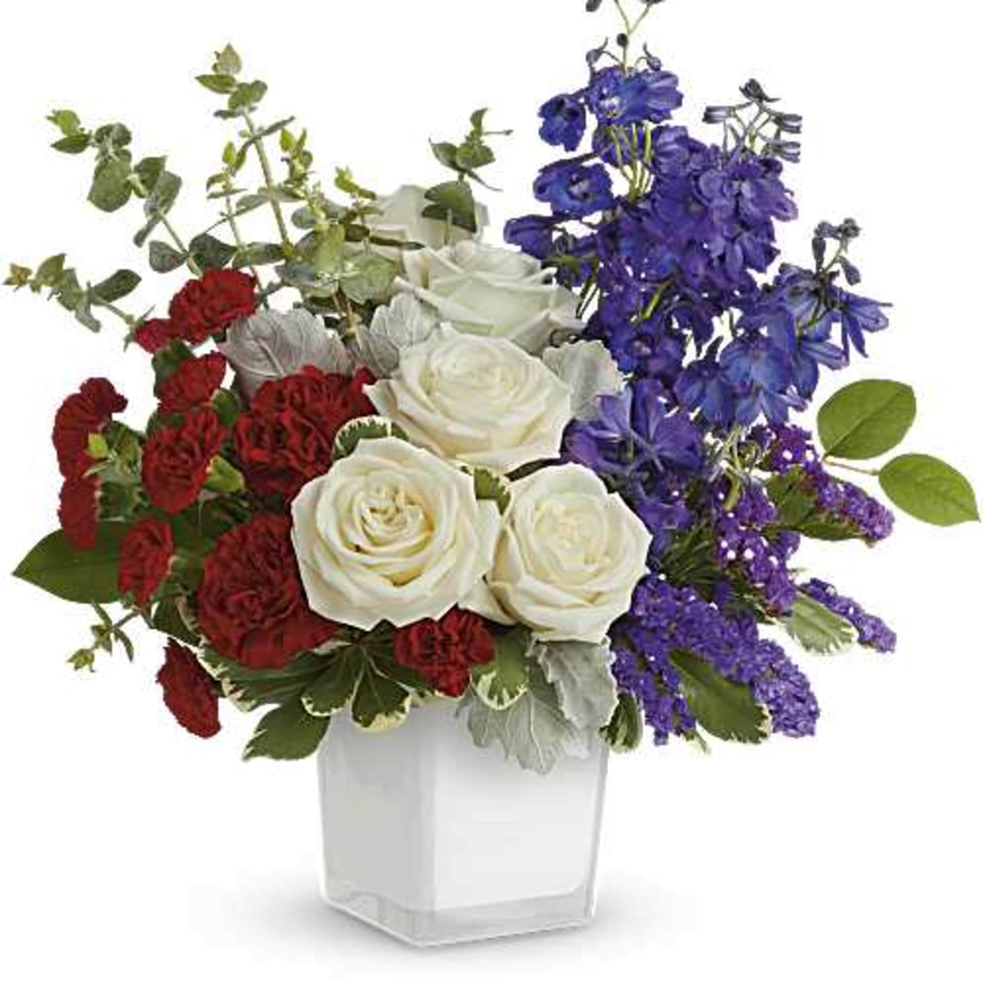 Red, white, and purple roses in a clear square vase