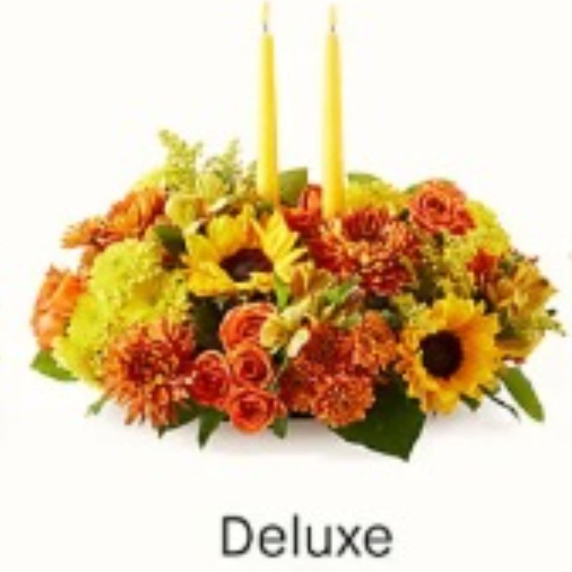 Autumn flower arrangement with two yellow taper candles