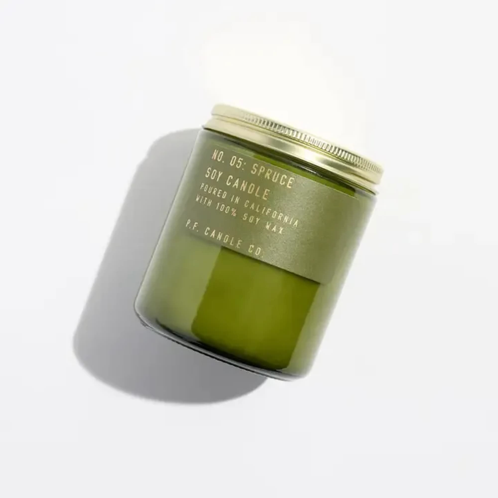 Green soy candle in a glass jar with a metal lid