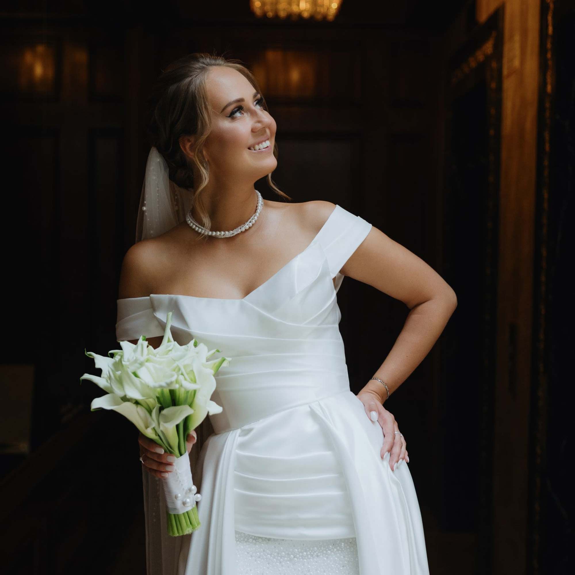 Bride holding a bouquet of white calla lilies