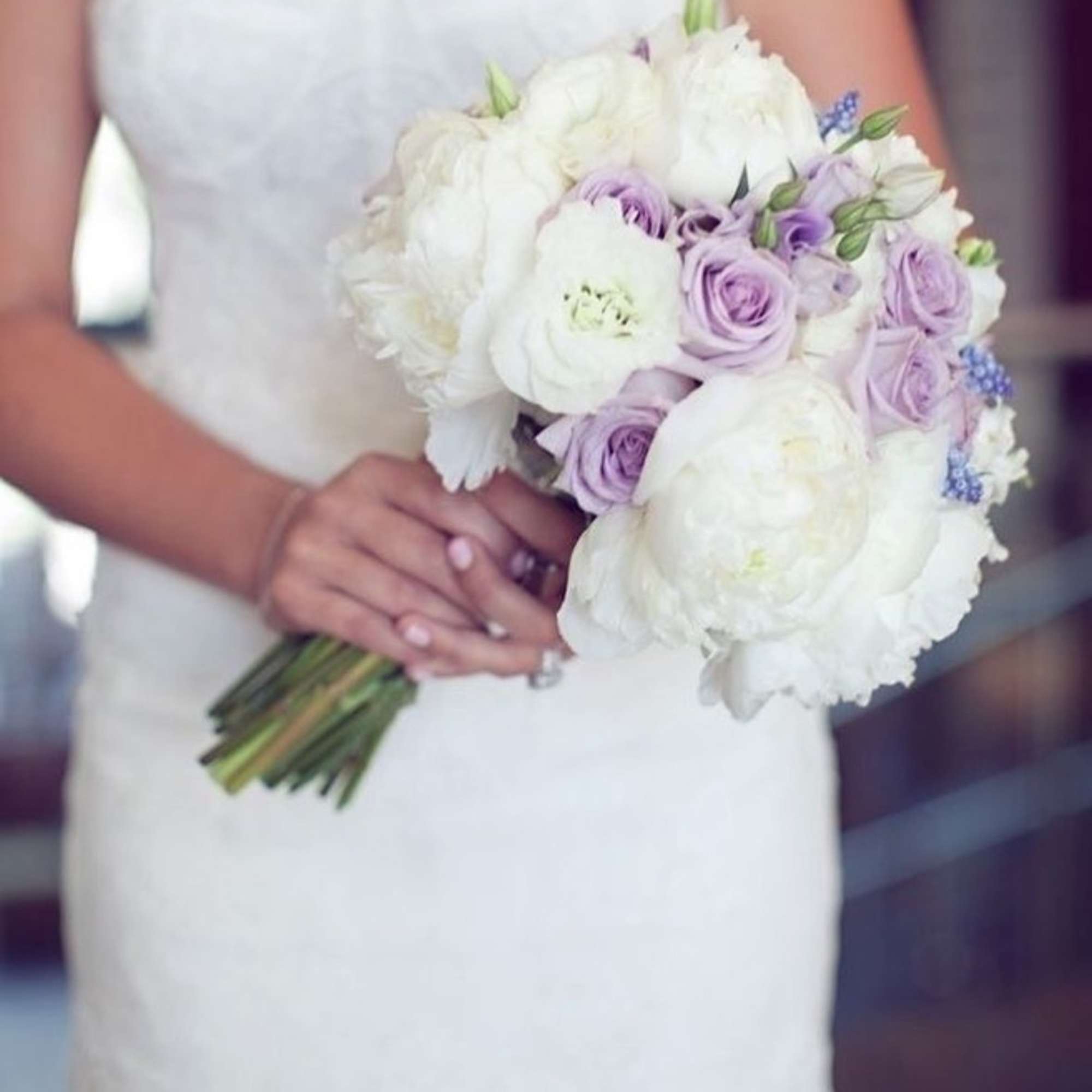 Bride holding a white and lavender bouquet