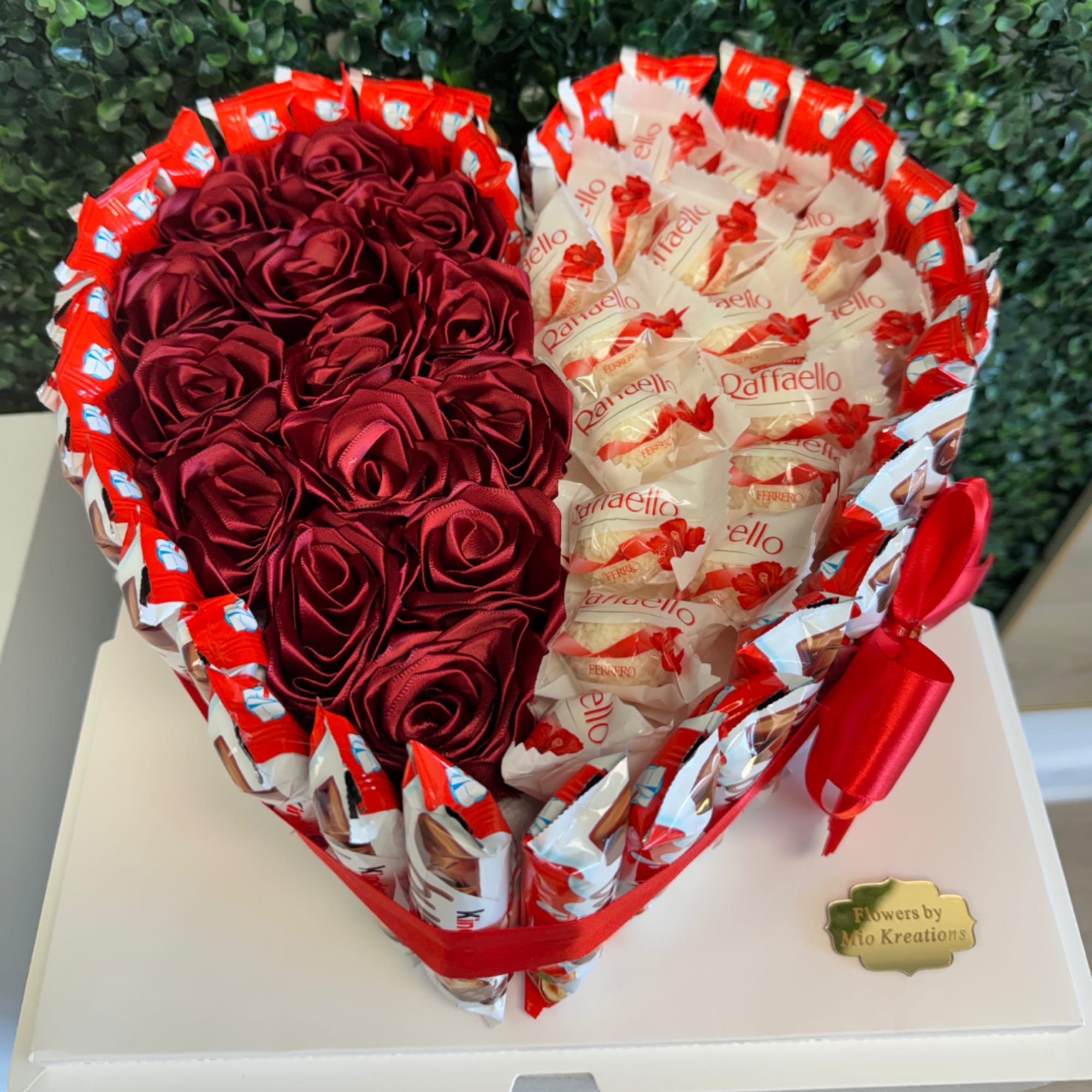 Heart-shaped gift box with red satin roses and Ferrero Rocher chocolates