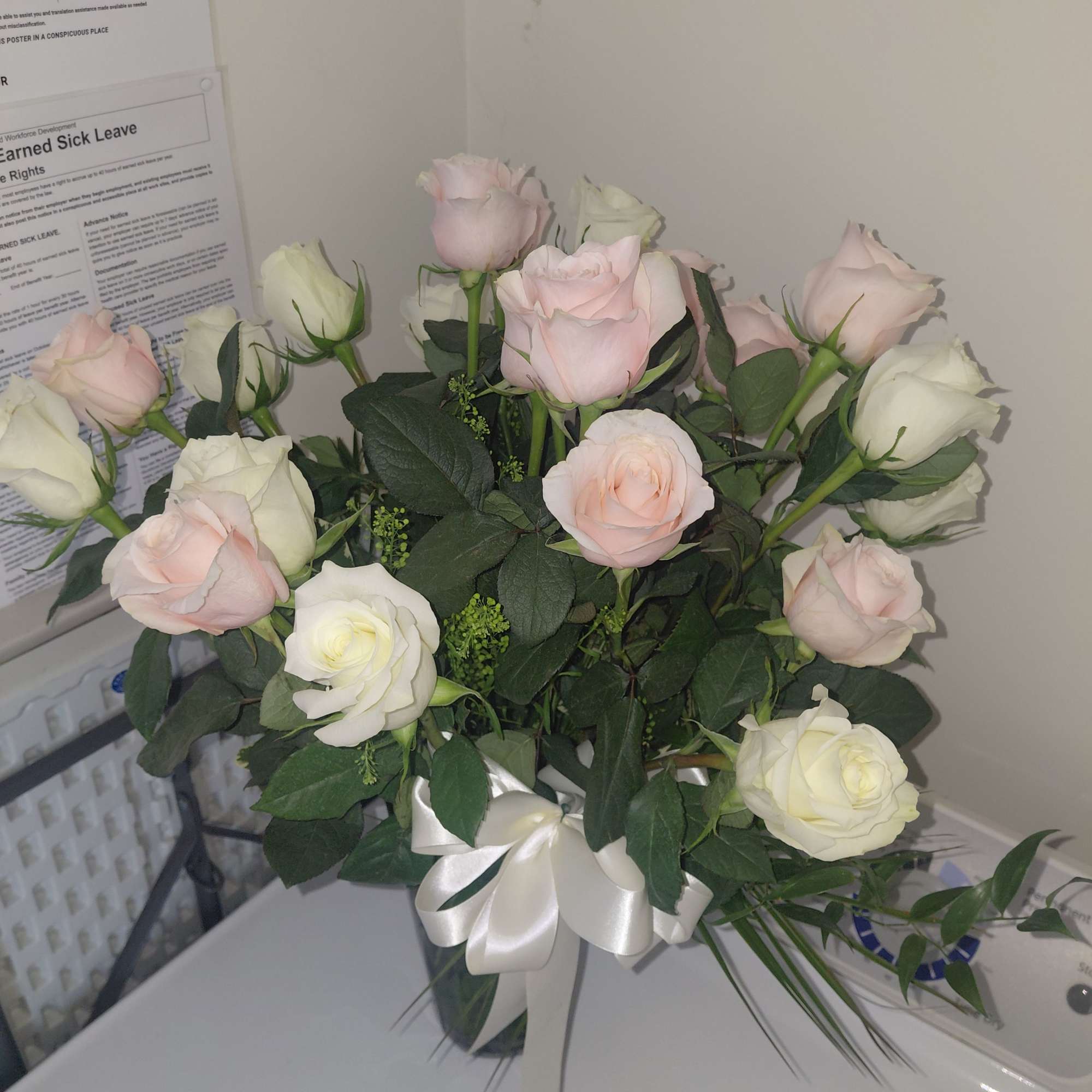 Picture  has Assorted Patel Colored  Roses  in a Tall