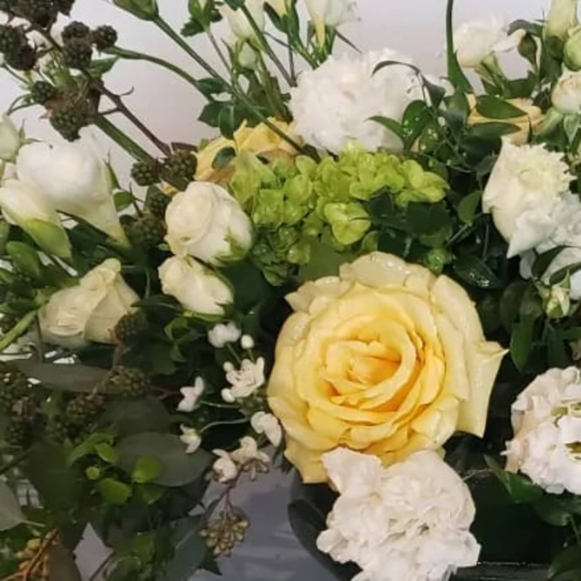 Bouquet of yellow and white roses with green hydrangea